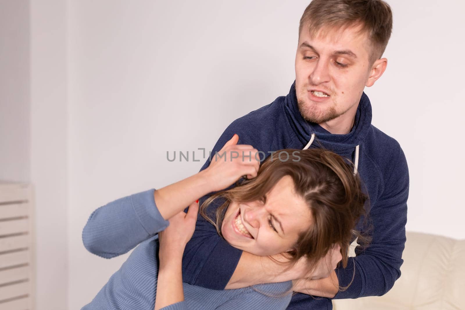 People, abuse and domestic violence concept - Portrait of man beating woman at home.