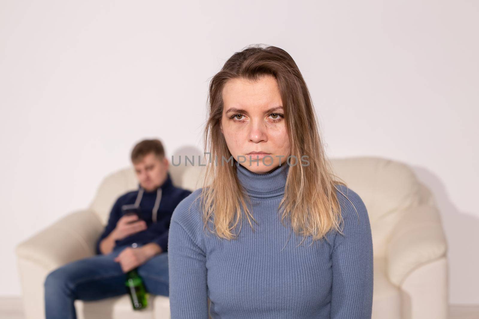 Alcoholism, abuse and domestic violence concept - sad woman with her drunk husband by Satura86