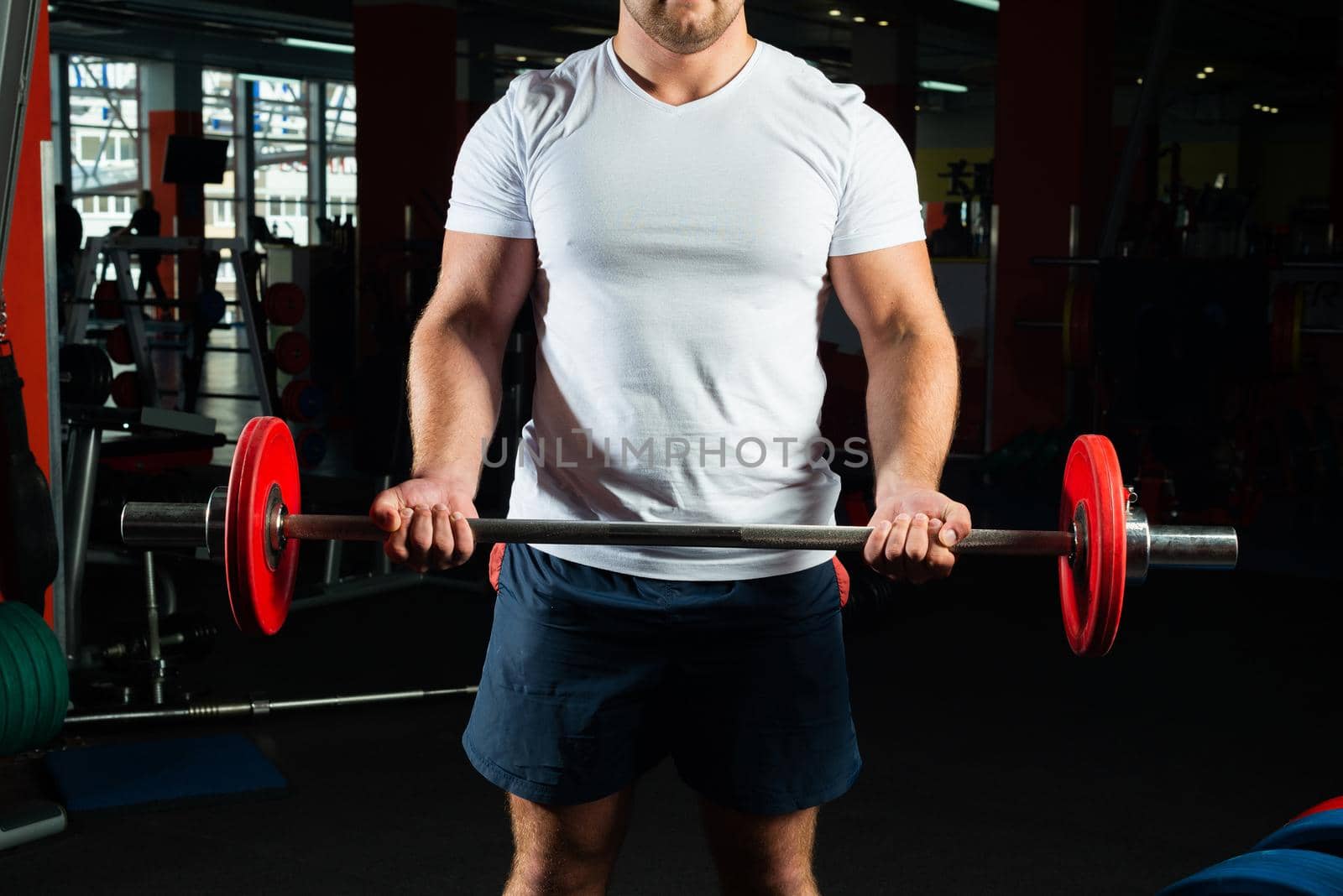 Man in the gym lifts the barbell. bodybuilding and healthy lifestyle