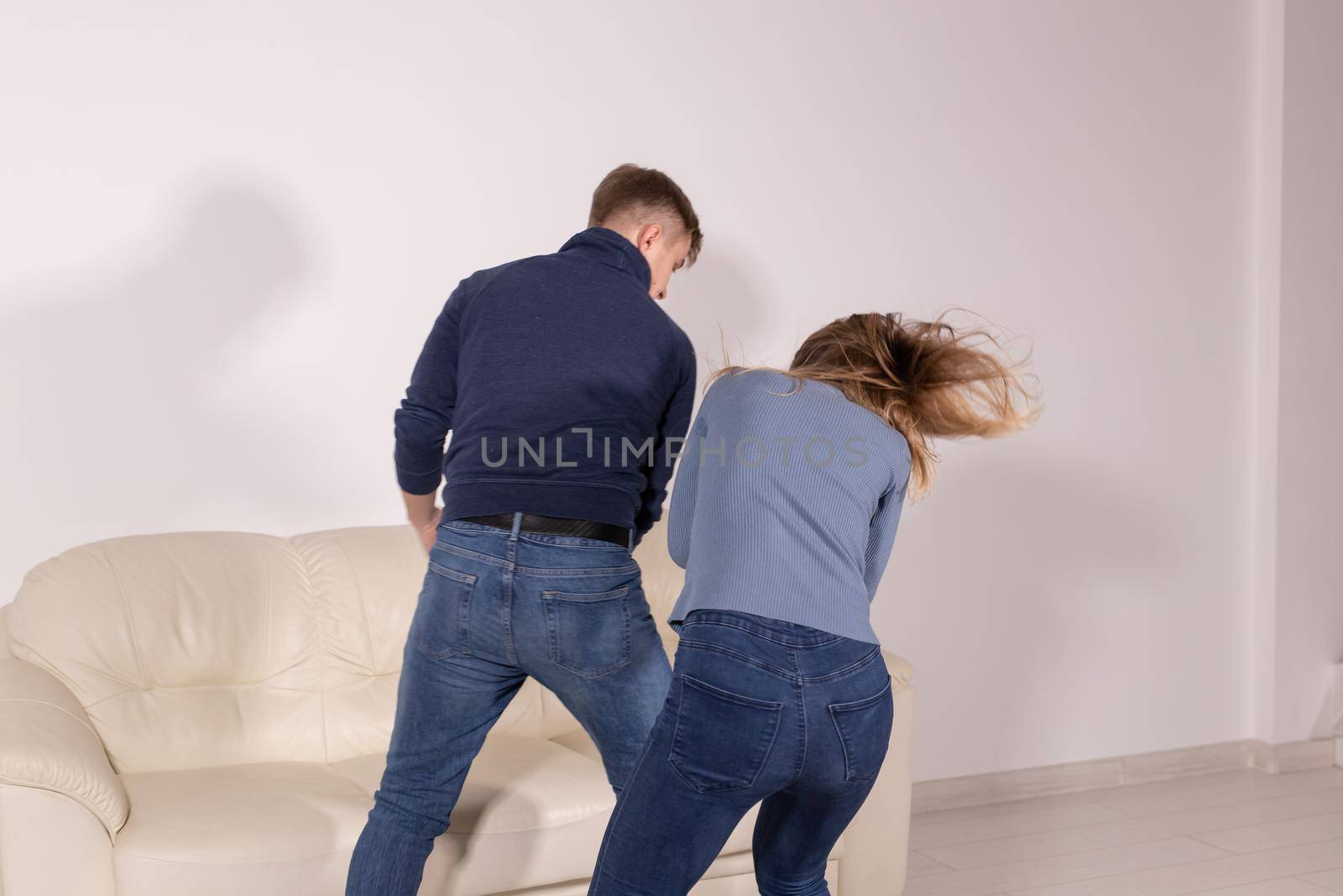 People and abuse concept - Aggressive man beats woman, domestic violence.