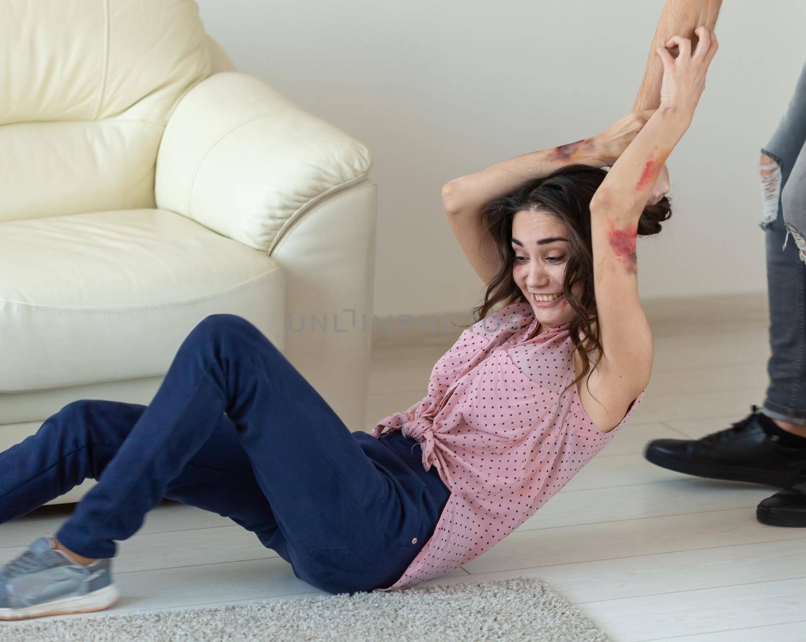 domestic violence, alcoholic and abuse concept - aggressive man grabbing his wife lying on the floor.