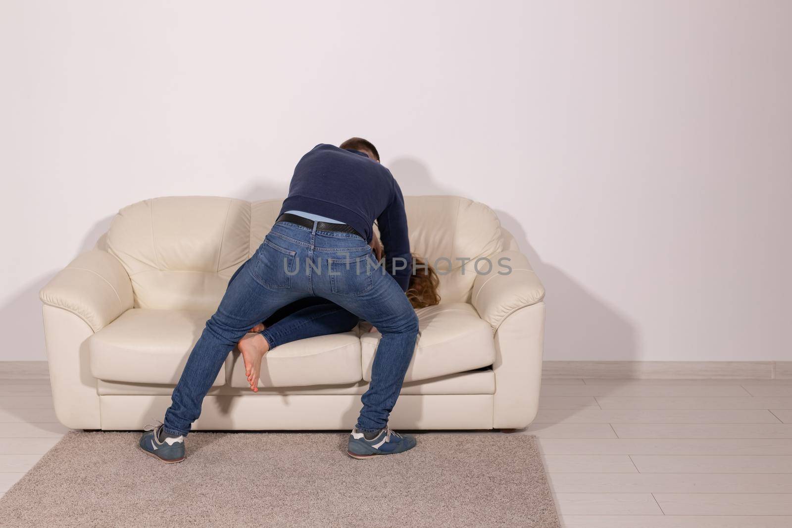 people, abuse and violence concept - aggressive man hitting his wife on sofa by Satura86