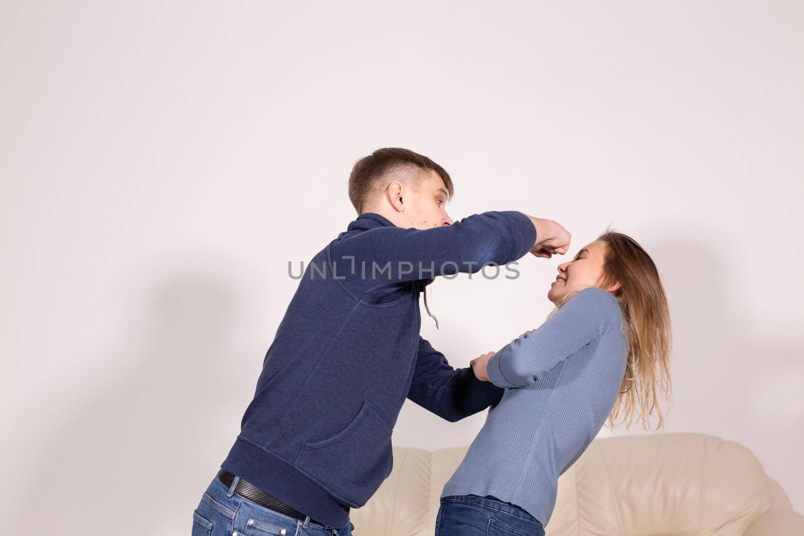 People and abuse concept - Portrait of angry young man try to hit the woman.