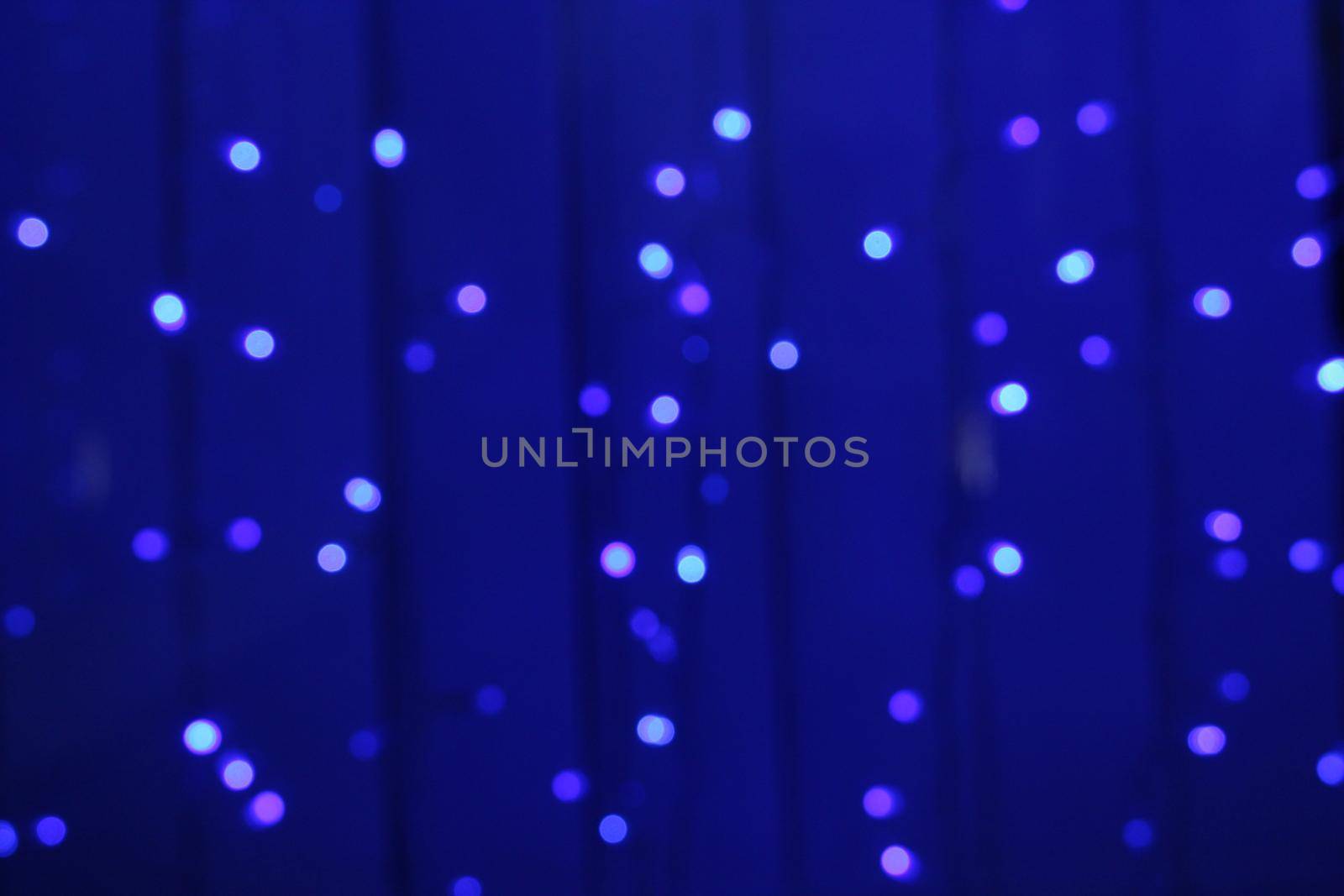 blue blurry background with garland. New Year Christmas.
