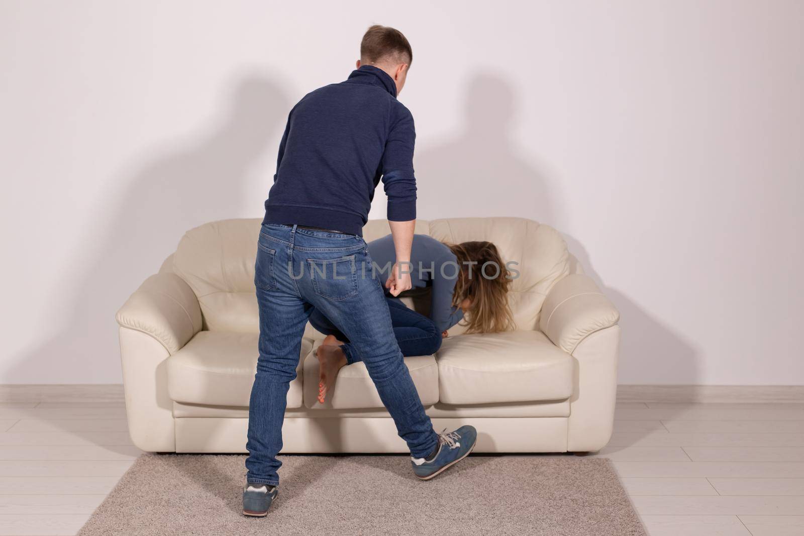 People, violence and abuse concept - man beating helpless woman at home background.