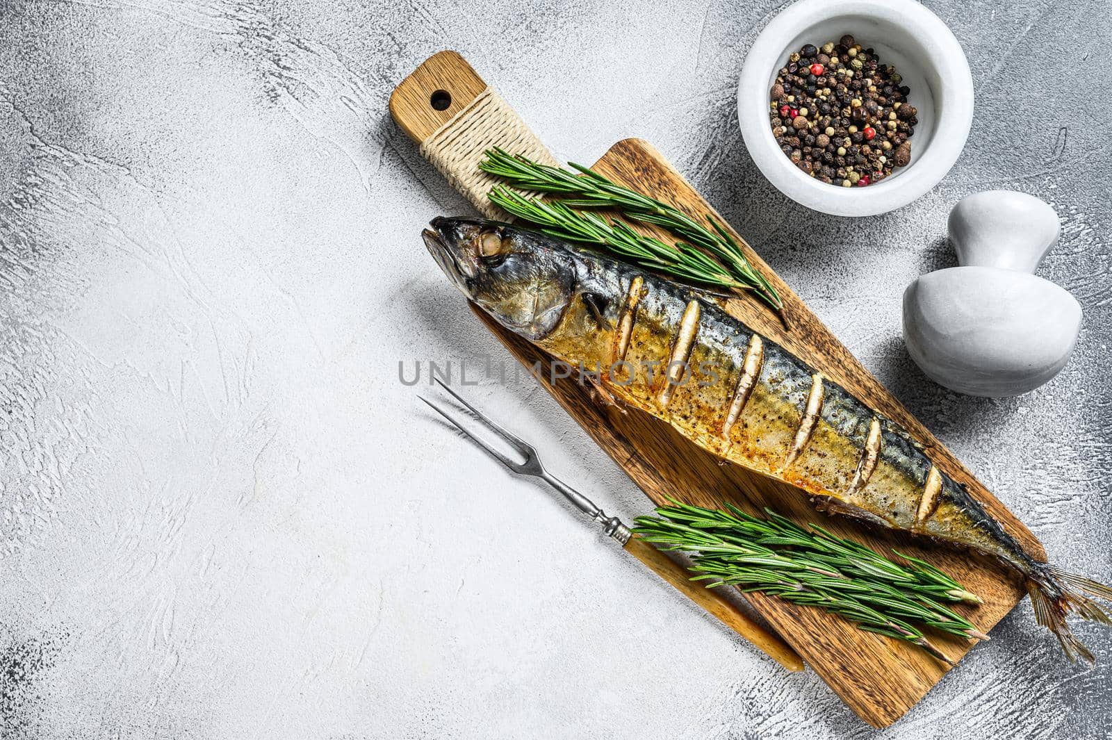 Oven baked whole mackerel fish with herbs. White background. Top view. Copy space.