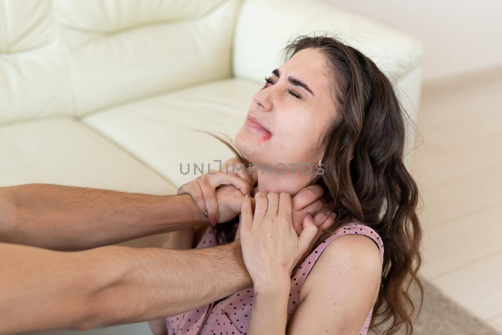 Victim, abuse and domestic violence - Woman being abused and strangled by strong man.