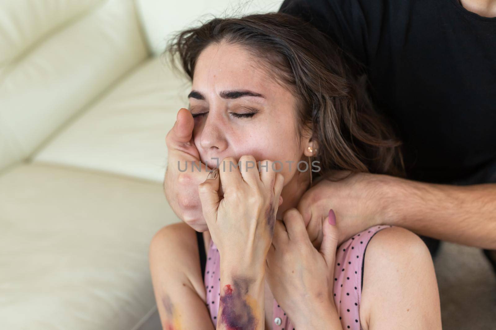 Victim, abuse and domestic violence - cruel man strangling his wife.