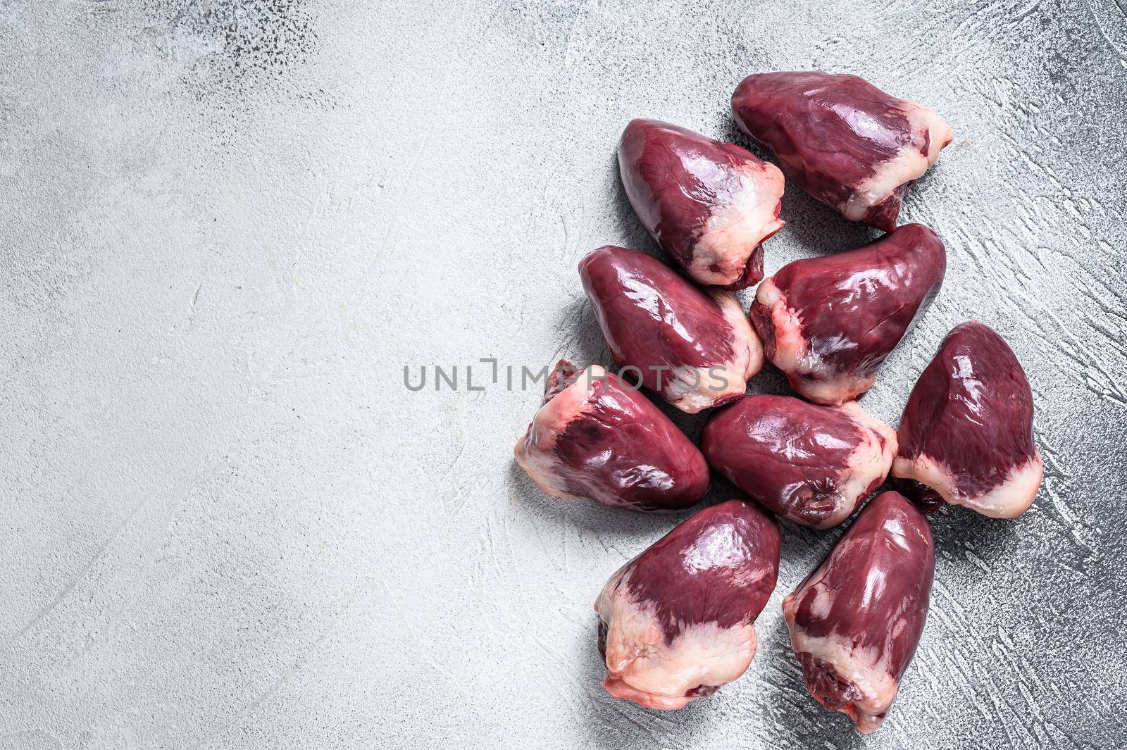 Raw turkey hearts offal. White background. Top view. Copy space.