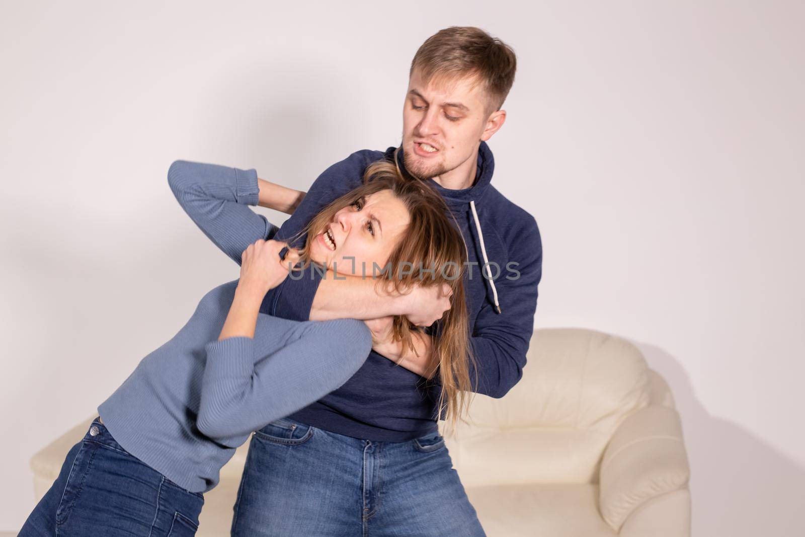 People, abuse and violence concept - aggressive man strangling his wife by Satura86