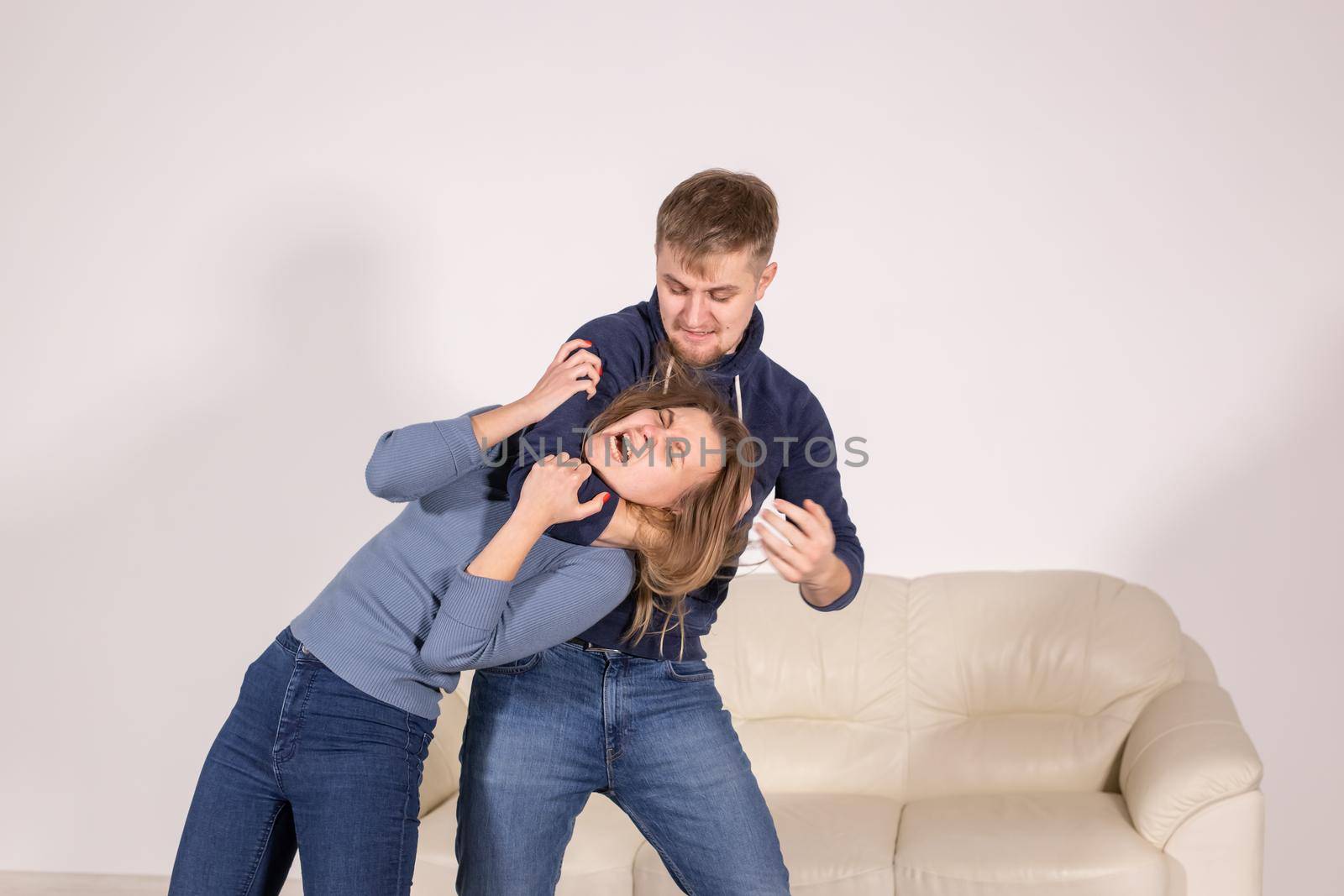 people, abuse and violence concept - agressive man strangling his wife by Satura86