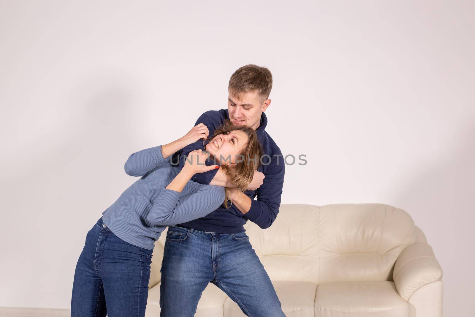 people, abuse and violence concept - agressive man strangling his wife by Satura86