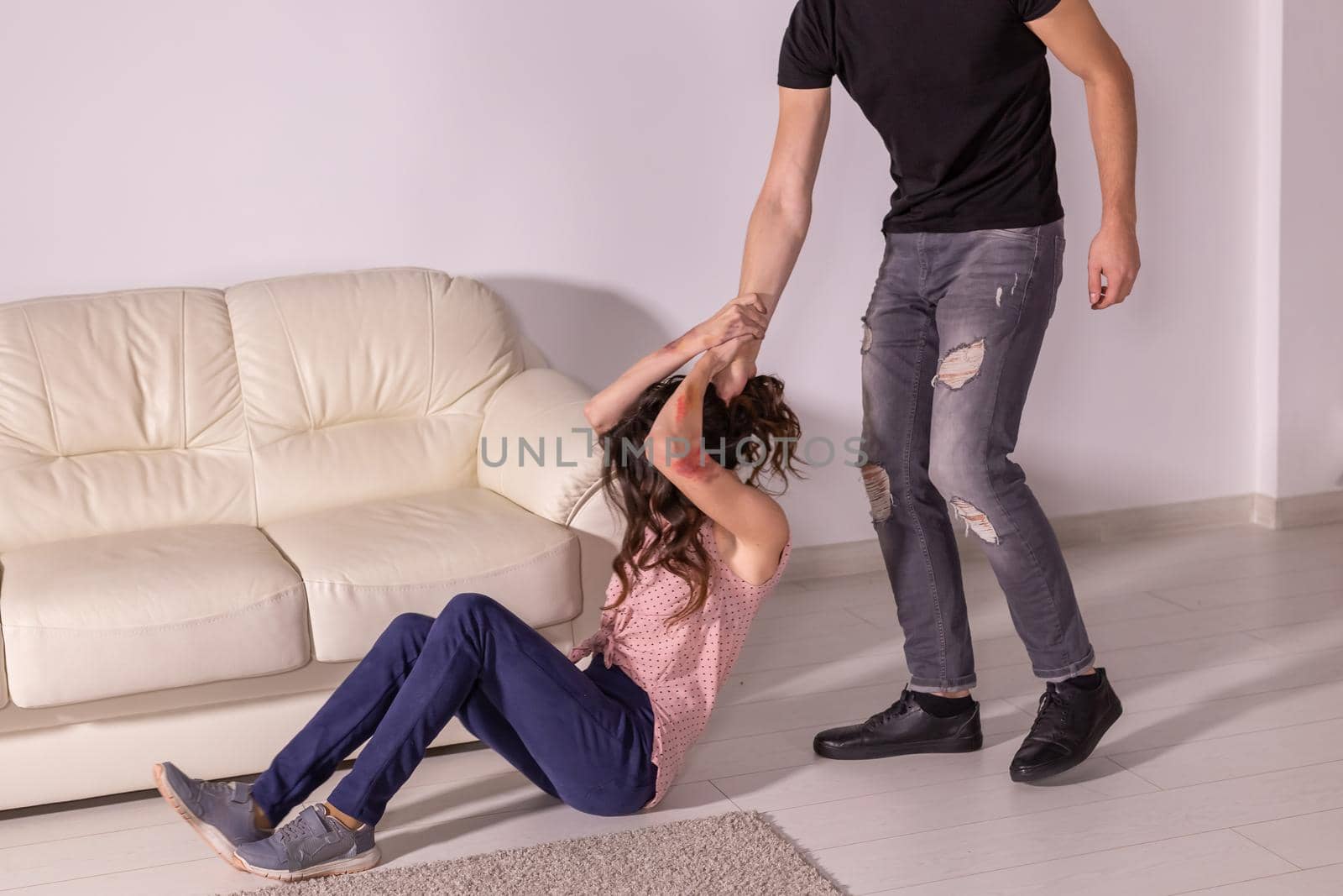 People and domestic violence - man and woman having fight, man dragging helpless woman by hair.