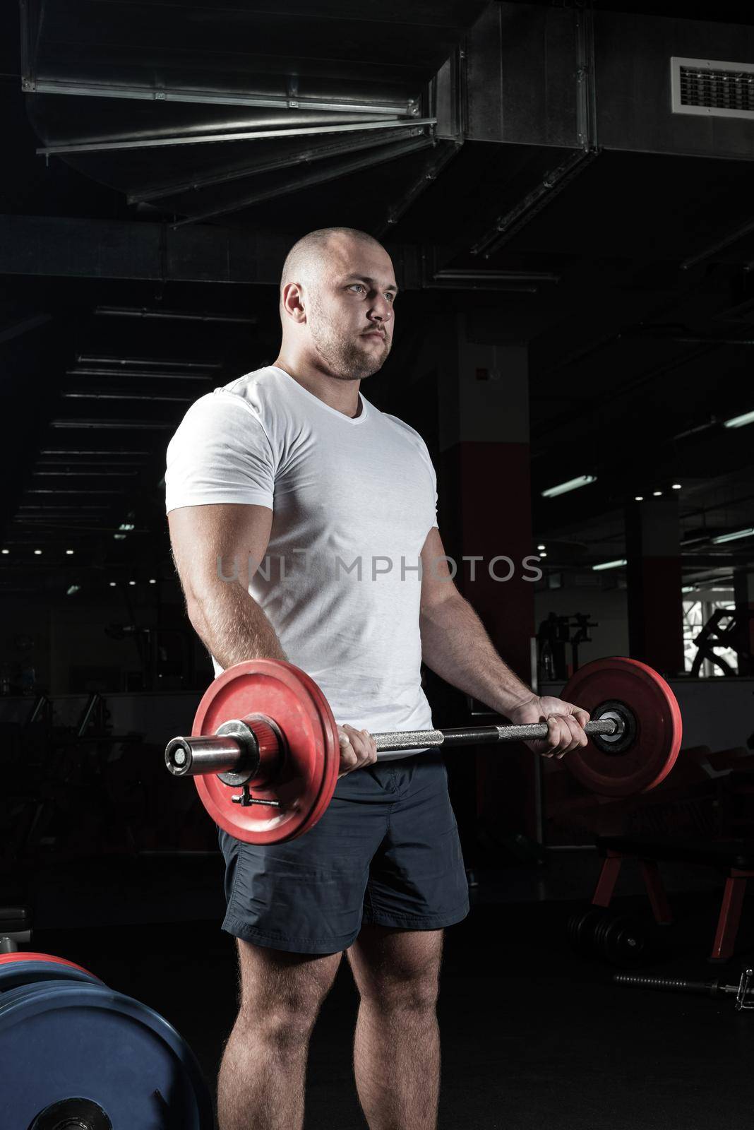 Male athlete lifts the barbell by adam121