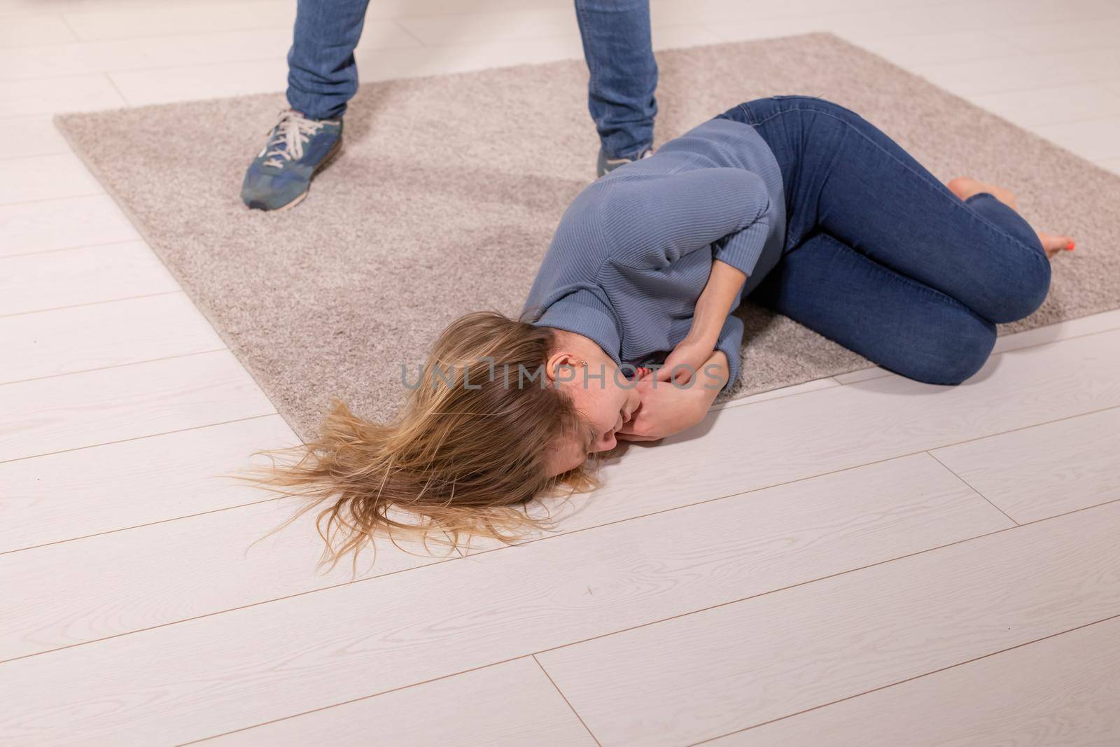 people, abuse and violence concept - woman threatened by husband lying on floor by Satura86