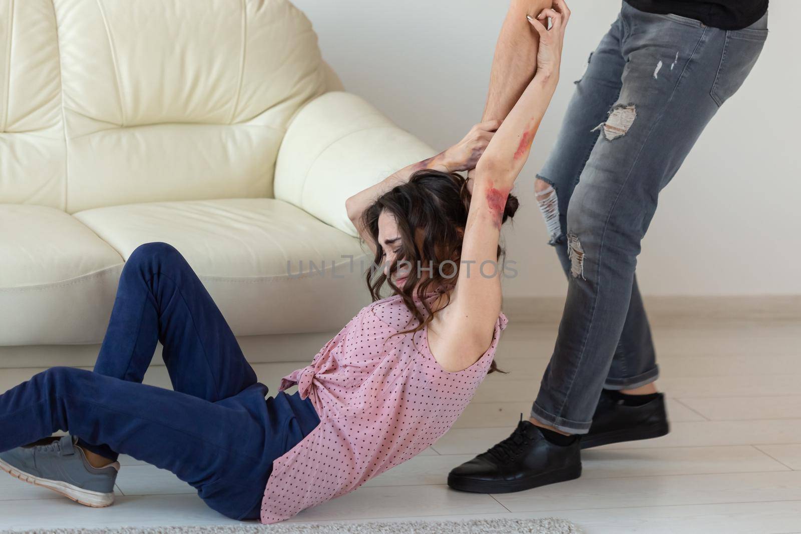 domestic violence, victim and abuse concept - couple having fight and man dragging helpless woman by hair.