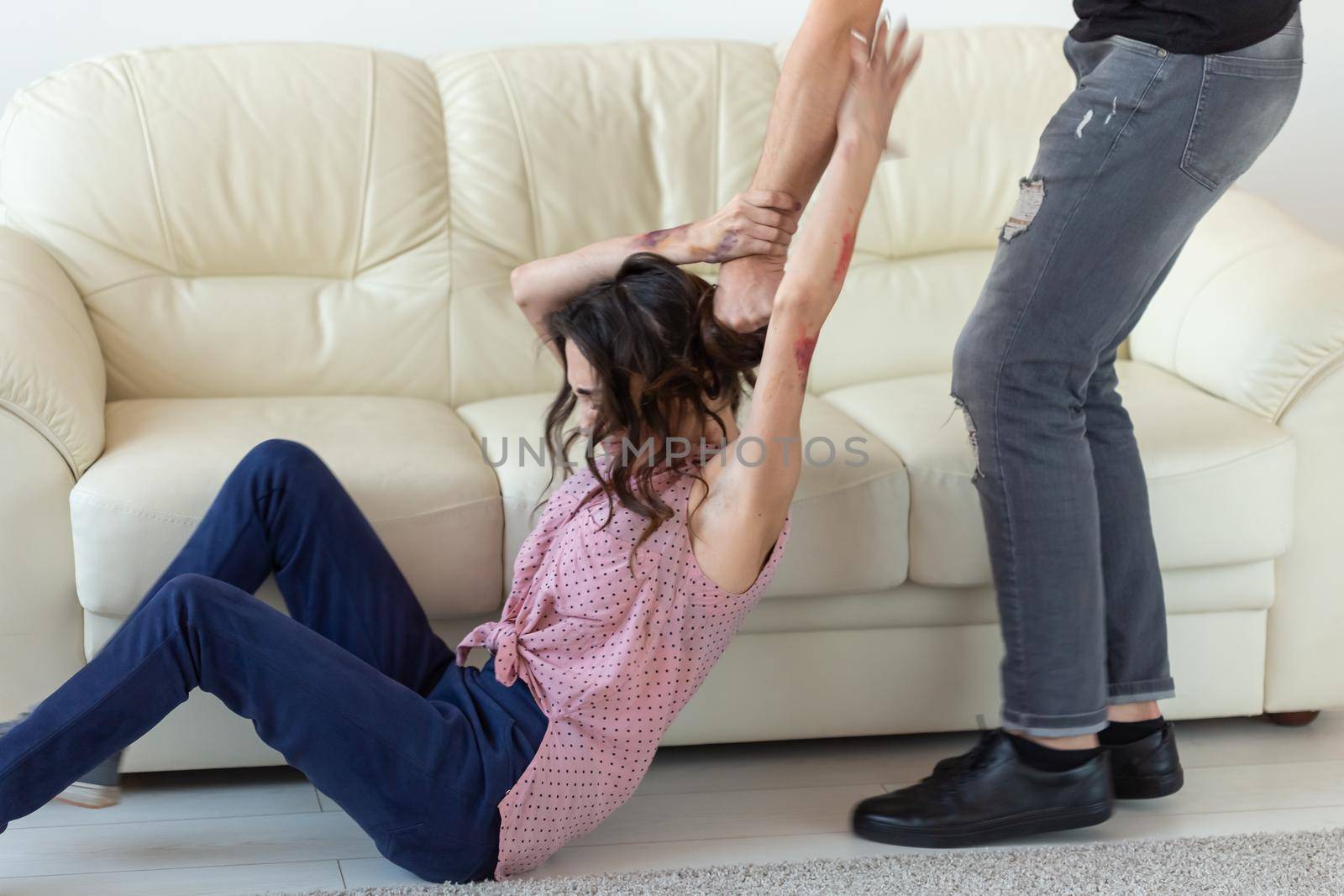 domestic violence, victim and abuse concept - couple having fight and man dragging helpless woman by hair.