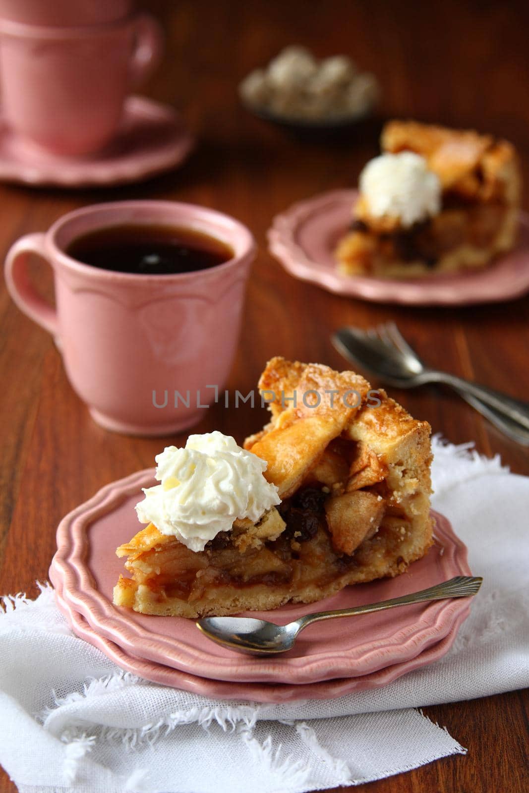 Slice of homemade dutch apple cake with whipped cream