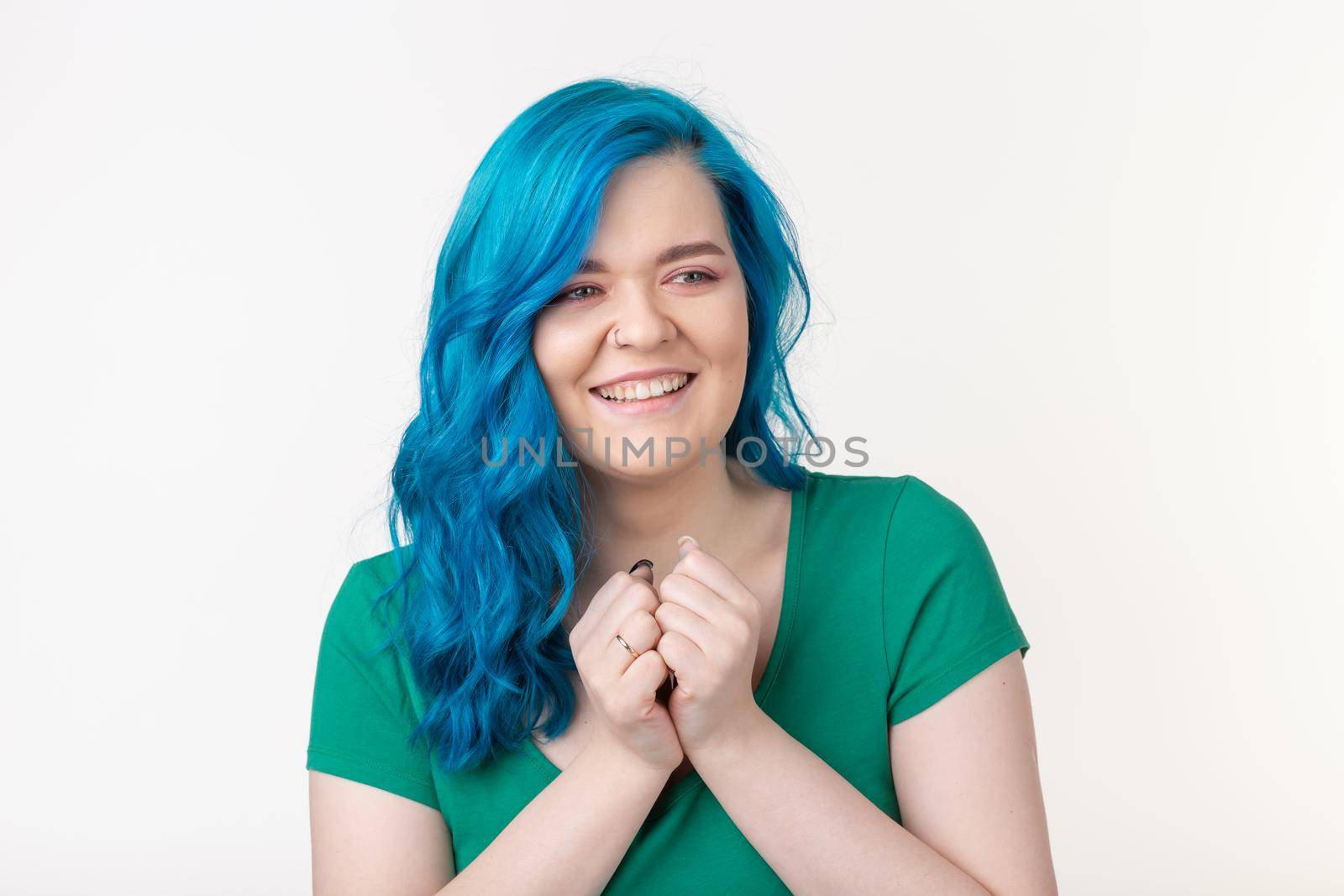 People, emotions and fashion concept - Beautiful girl with blue hair and joyful face on white background.