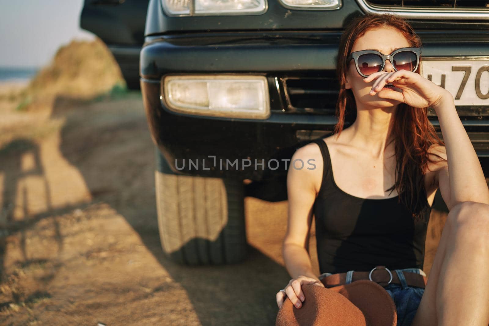 woman in sunglasses near car travel summer vacation landscape. High quality photo