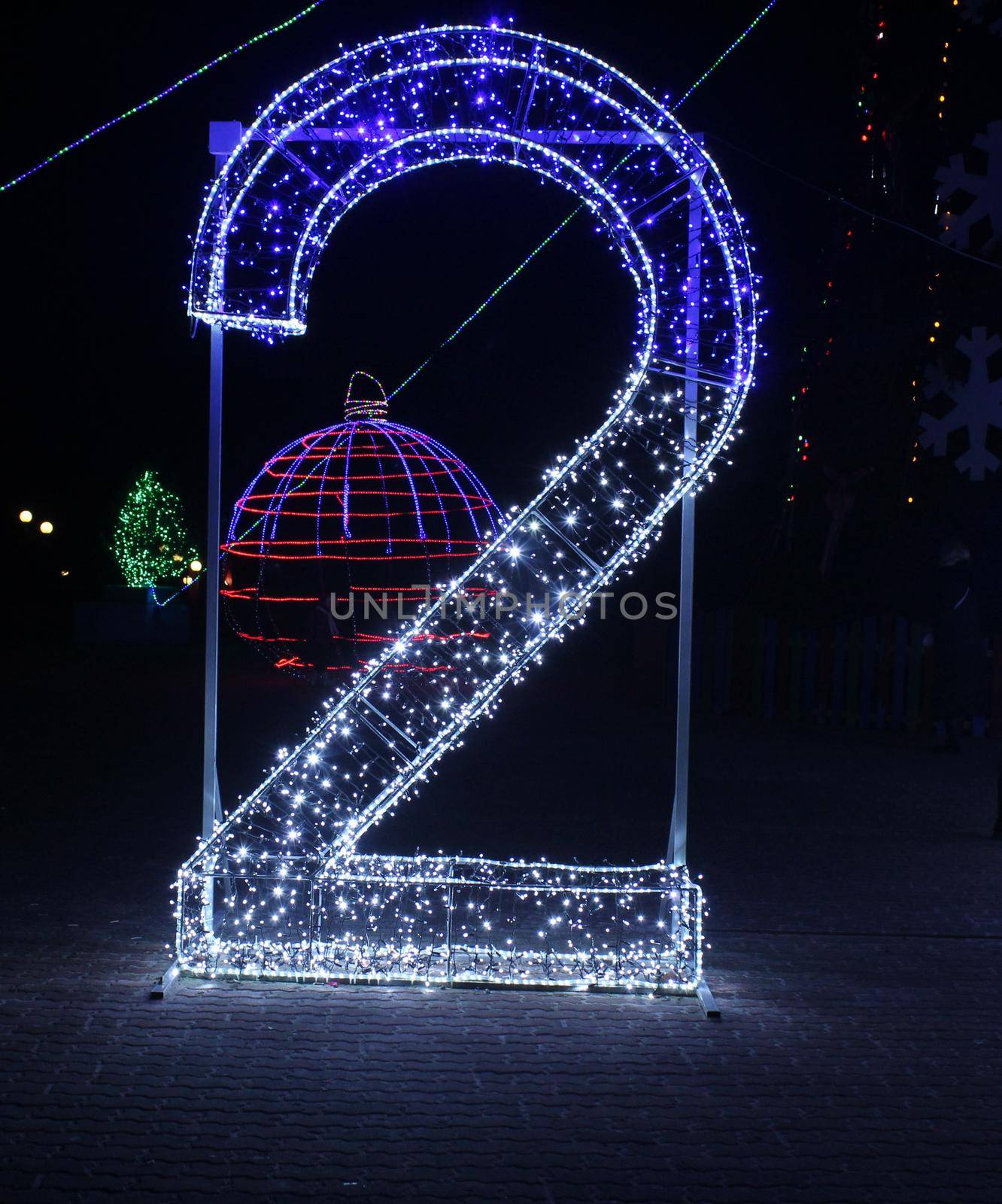 Number 2 two blue white and garlands of lighting. New Year Christmas Illumination Symbol of the Year Date.