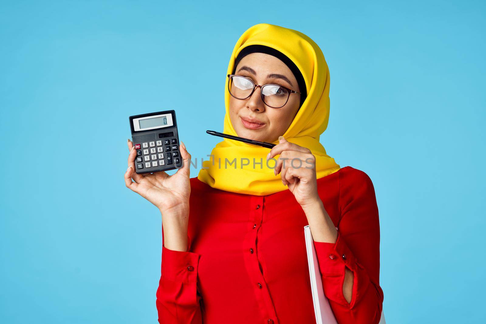 muslim woman in hijab shopping entertainment blue background. High quality photo