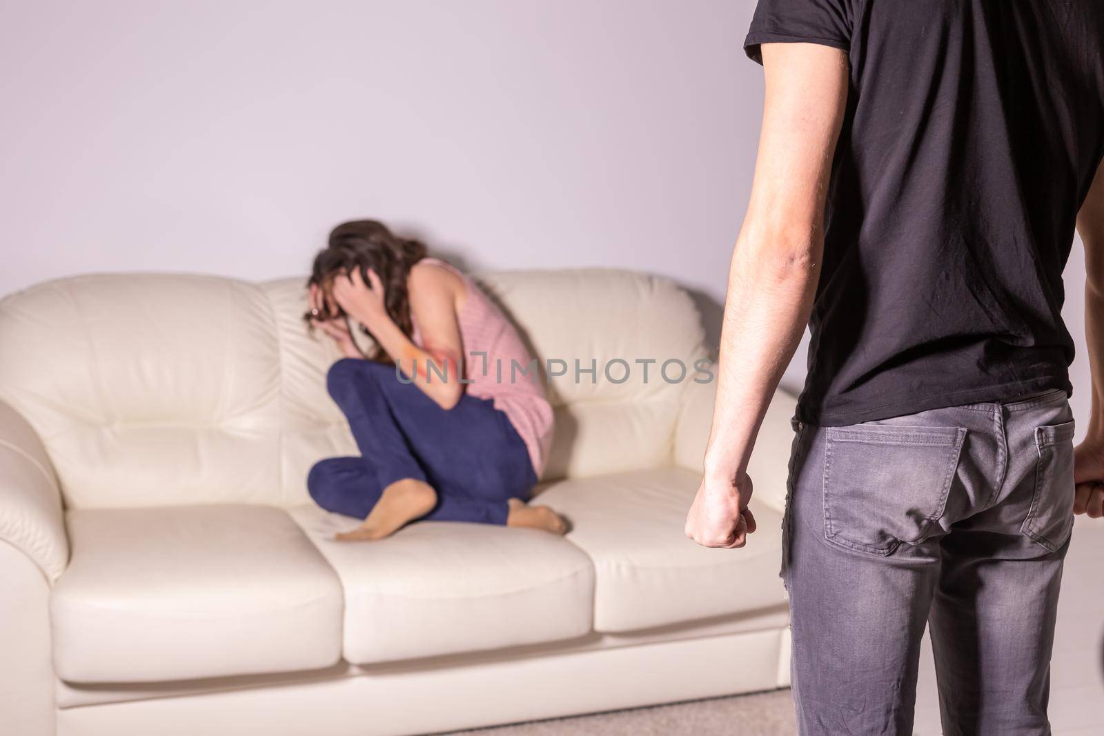 Domestic violence and abuse concept - man threatening with fist to crying woman by Satura86
