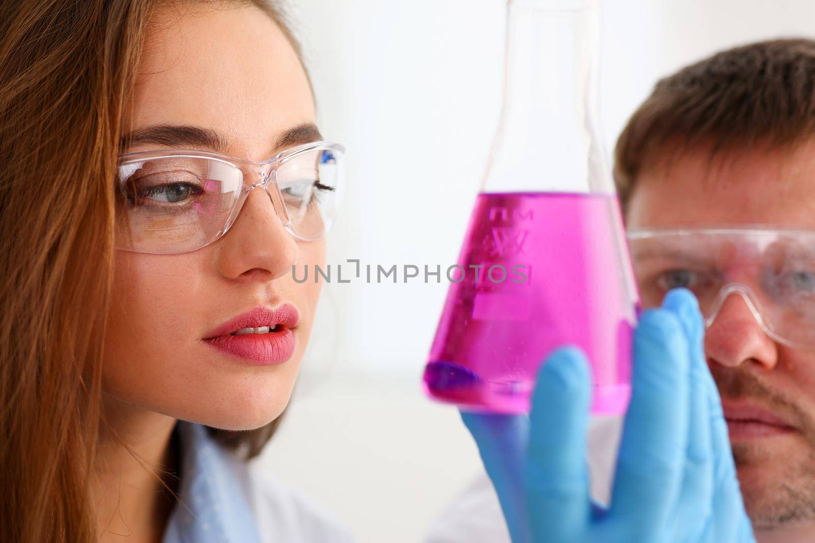 Technician hold in arms in protective gloves sample bottle with poison fluid portrait. Medical worker in uniform use reagent tube for virus infection exam or biological toxic reaction, drug creation