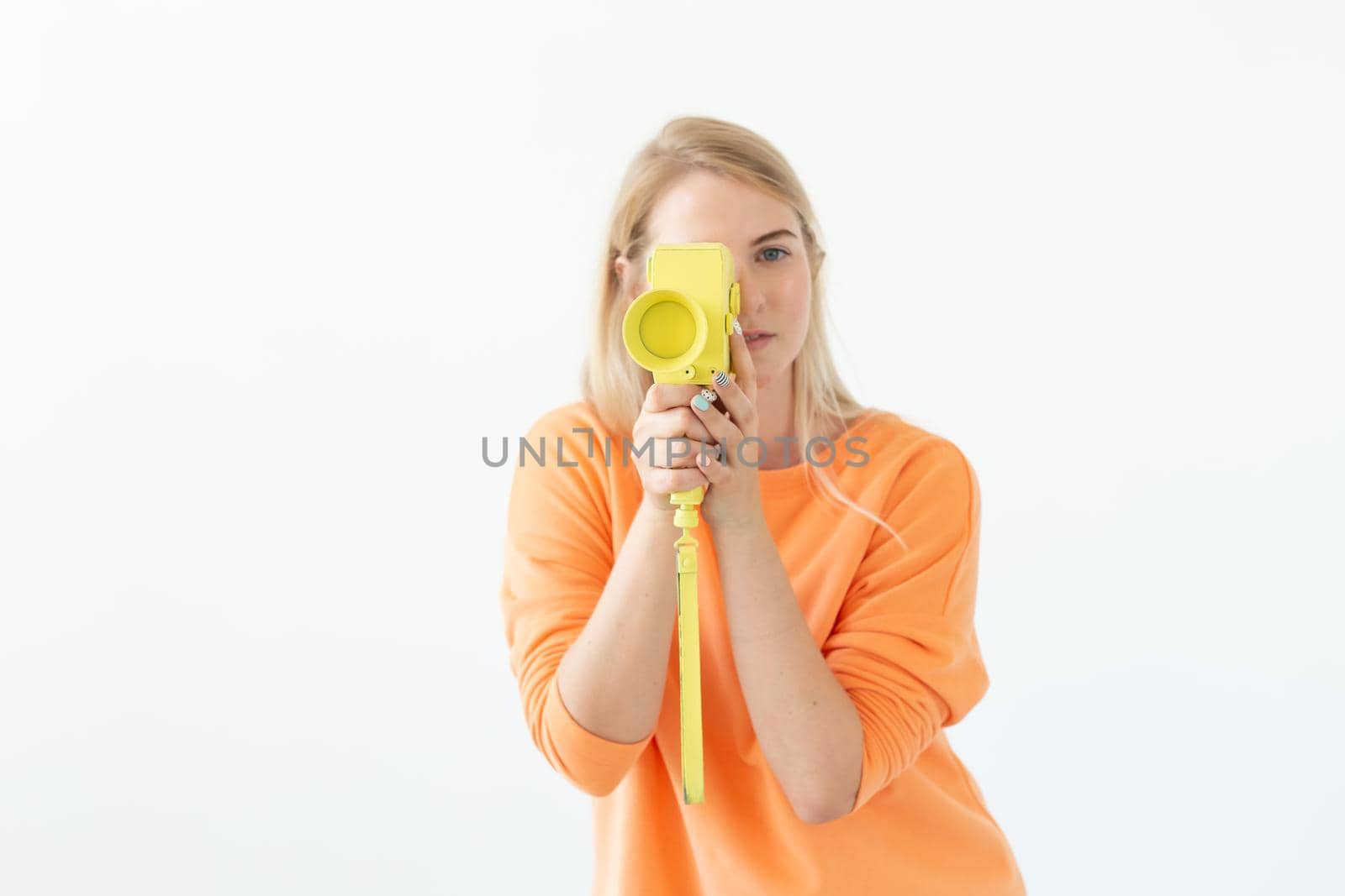 Photographer, hobby and leisure concept - Young blond woman with retro camera on white background with copy space.