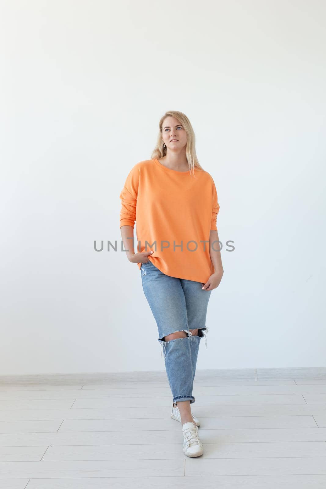 Portrait of pretty young woman in casual clothes posing on a white background. Space for reference links or advertising.