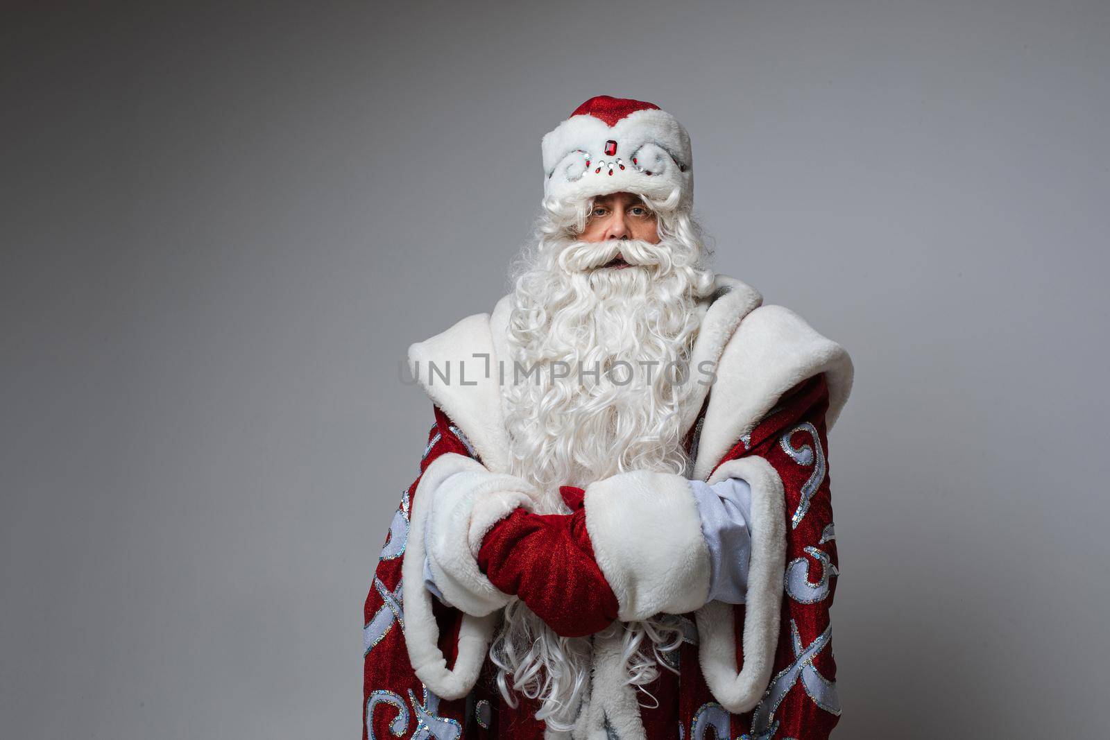 Calm Santa with hands together looking at camera. by StudioLucky