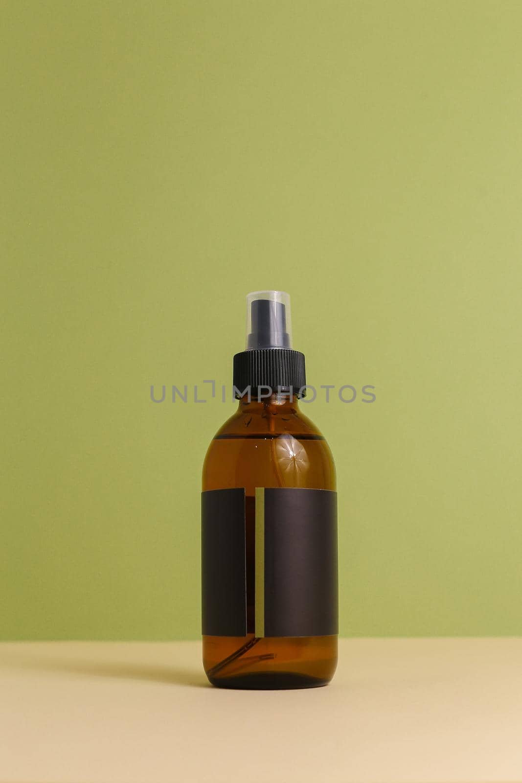 Moisturizing serum for dry skin with pipette on green background by sisterspro