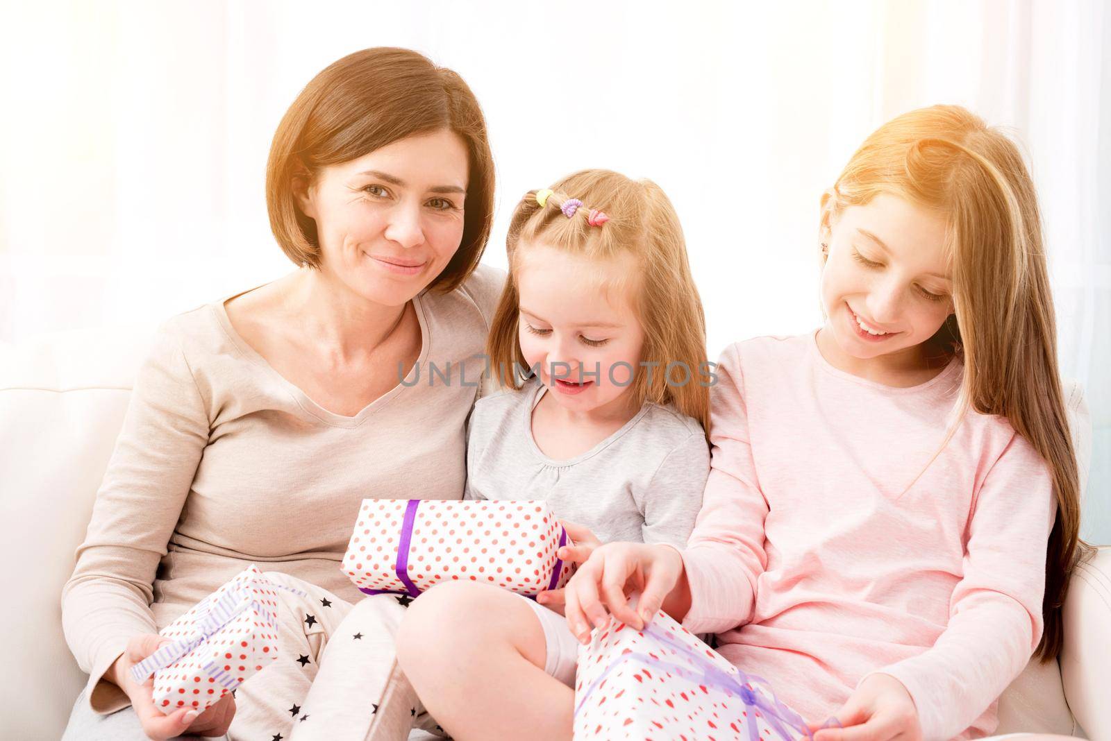 Mom and her daughters exchanging gifts by GekaSkr