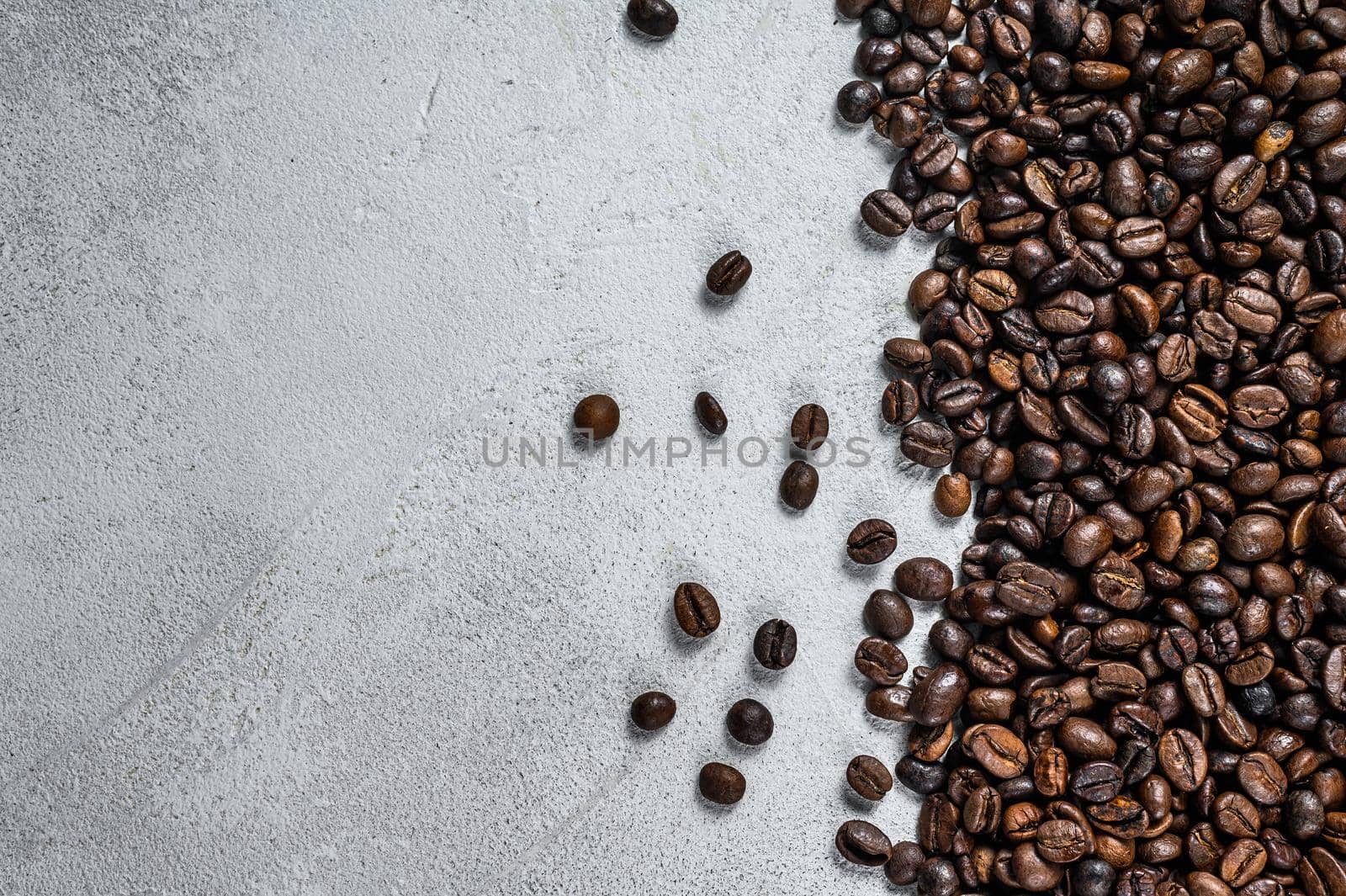 Roasted coffee beans on rustic table. White background. Top view. Copy space by Composter