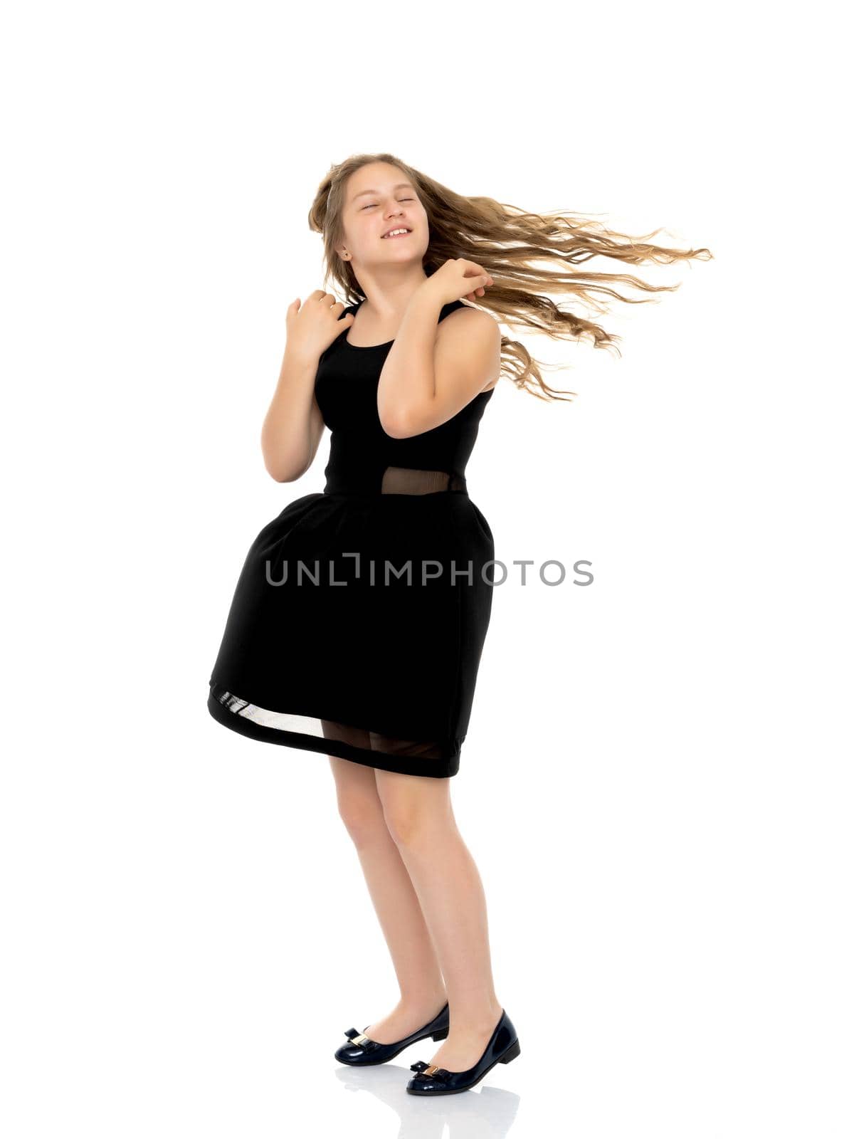 A schoolgirl girl with beautiful long hair. Isolated on white background.