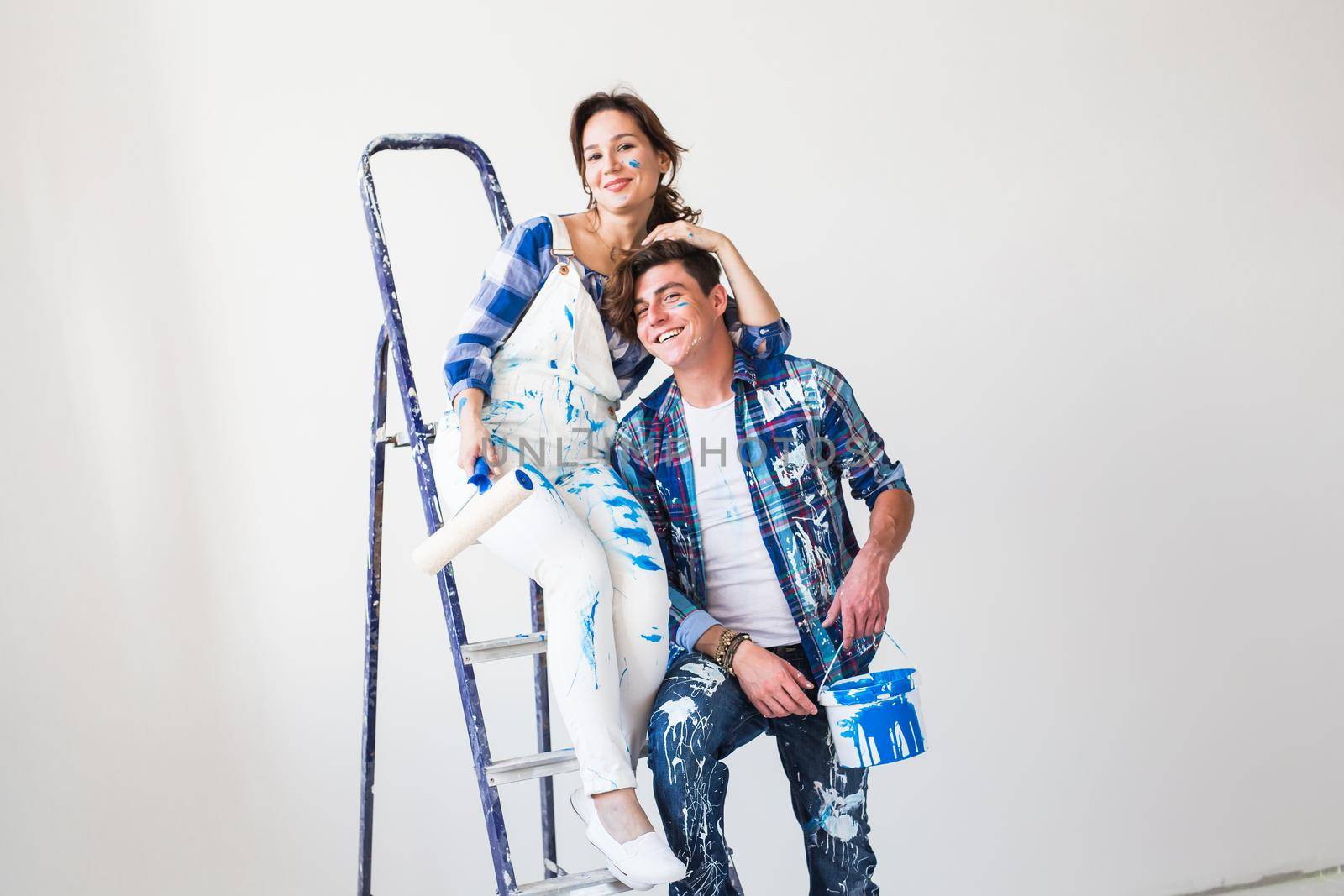 Renovation, repair and people concept - young couple doing a renovation in new home.