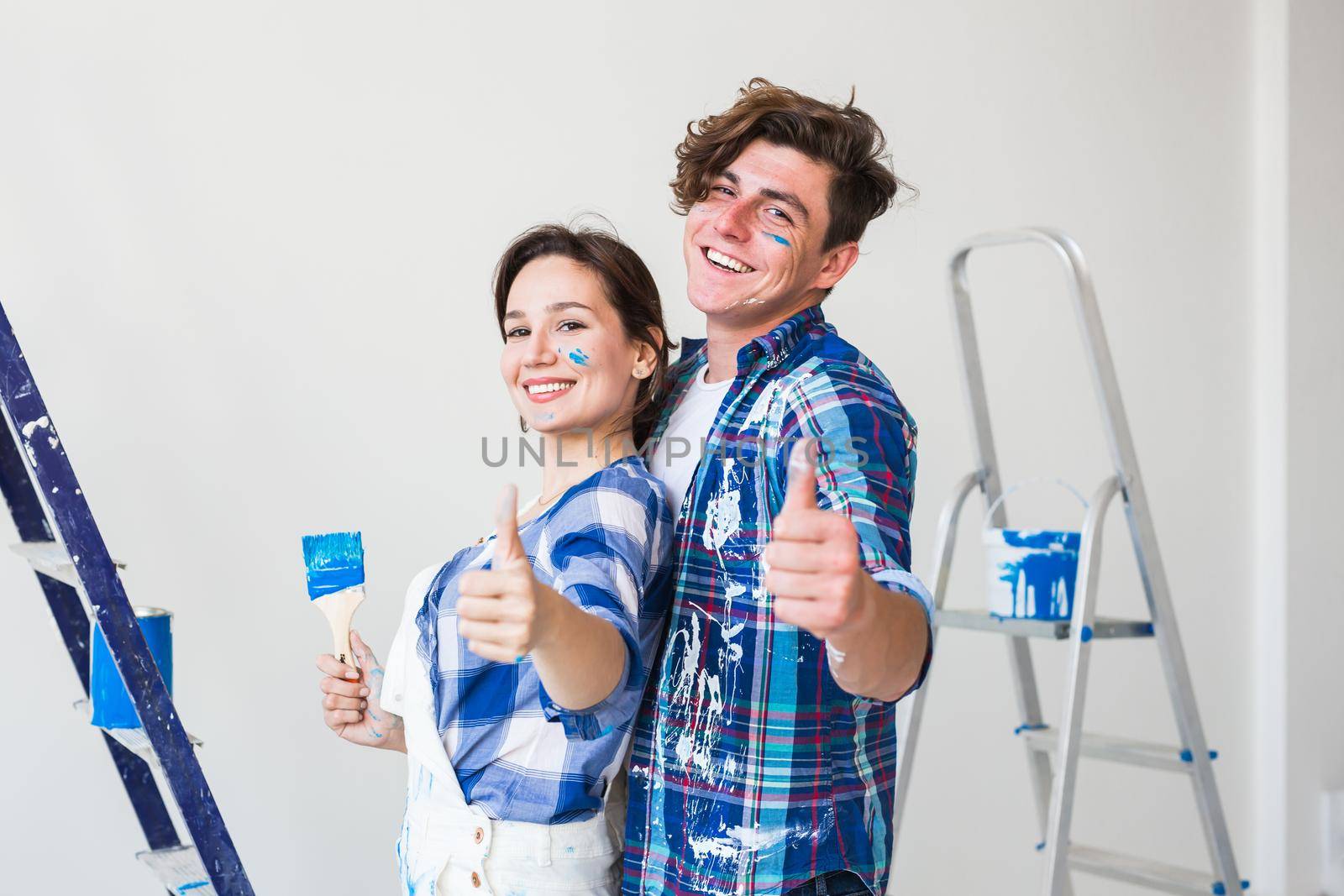 Repair, renovation and people concept - Woman and man gestured thumbs up.