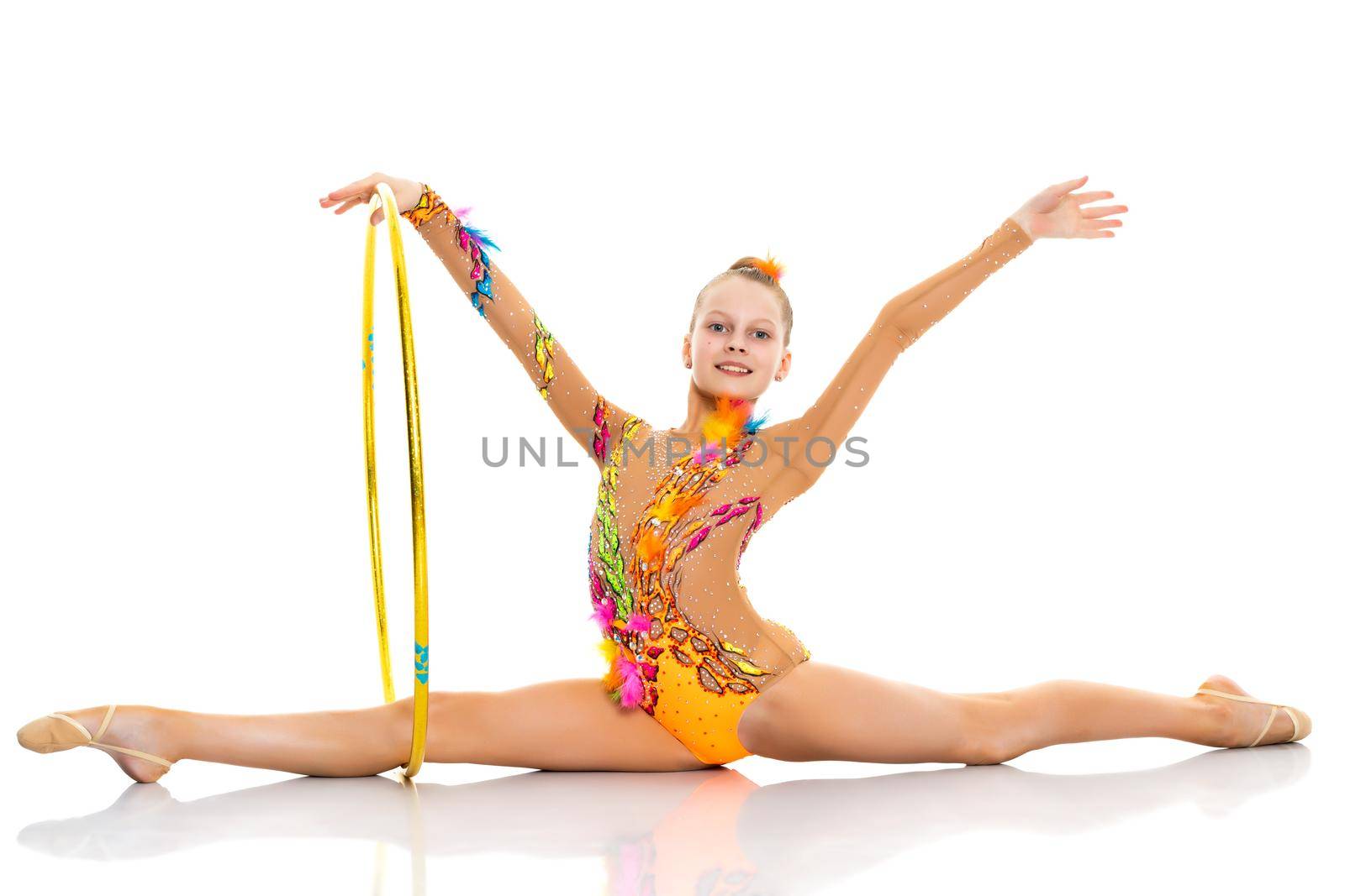 A girl gymnast performs an exercise with a hoop. by kolesnikov_studio