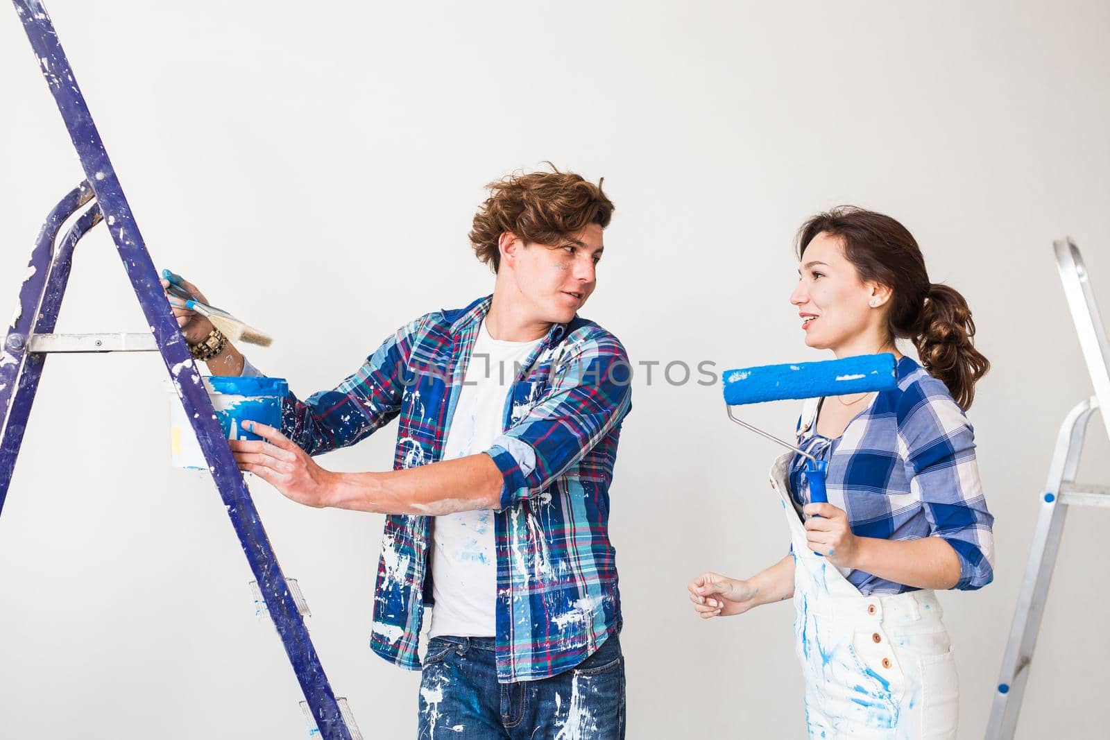 People, renovation and repair concept - Portrait of lovely couple doing redecoration in apartment by Satura86