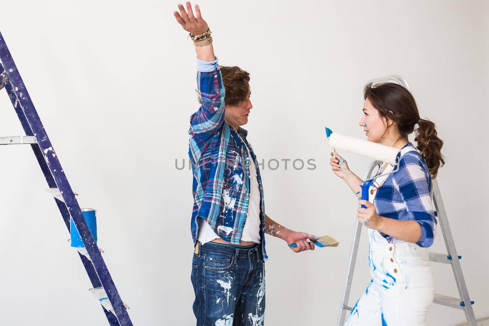 Conflict, redecoration, renovation and people concept - a couple doing a repair in apartment and argue by Satura86