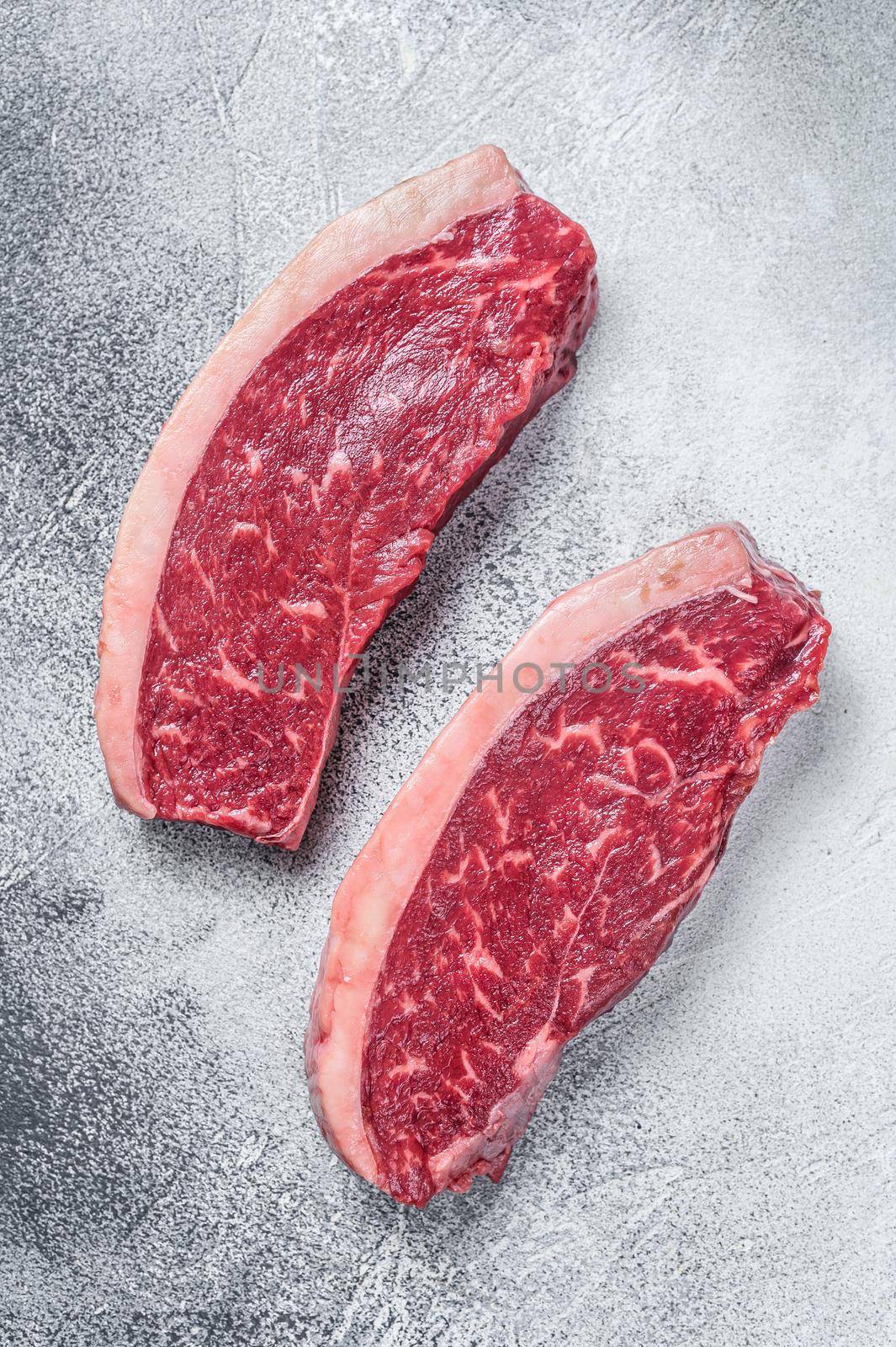 Raw cap rump or top sirloin beef meat steak. White background. Top view by Composter