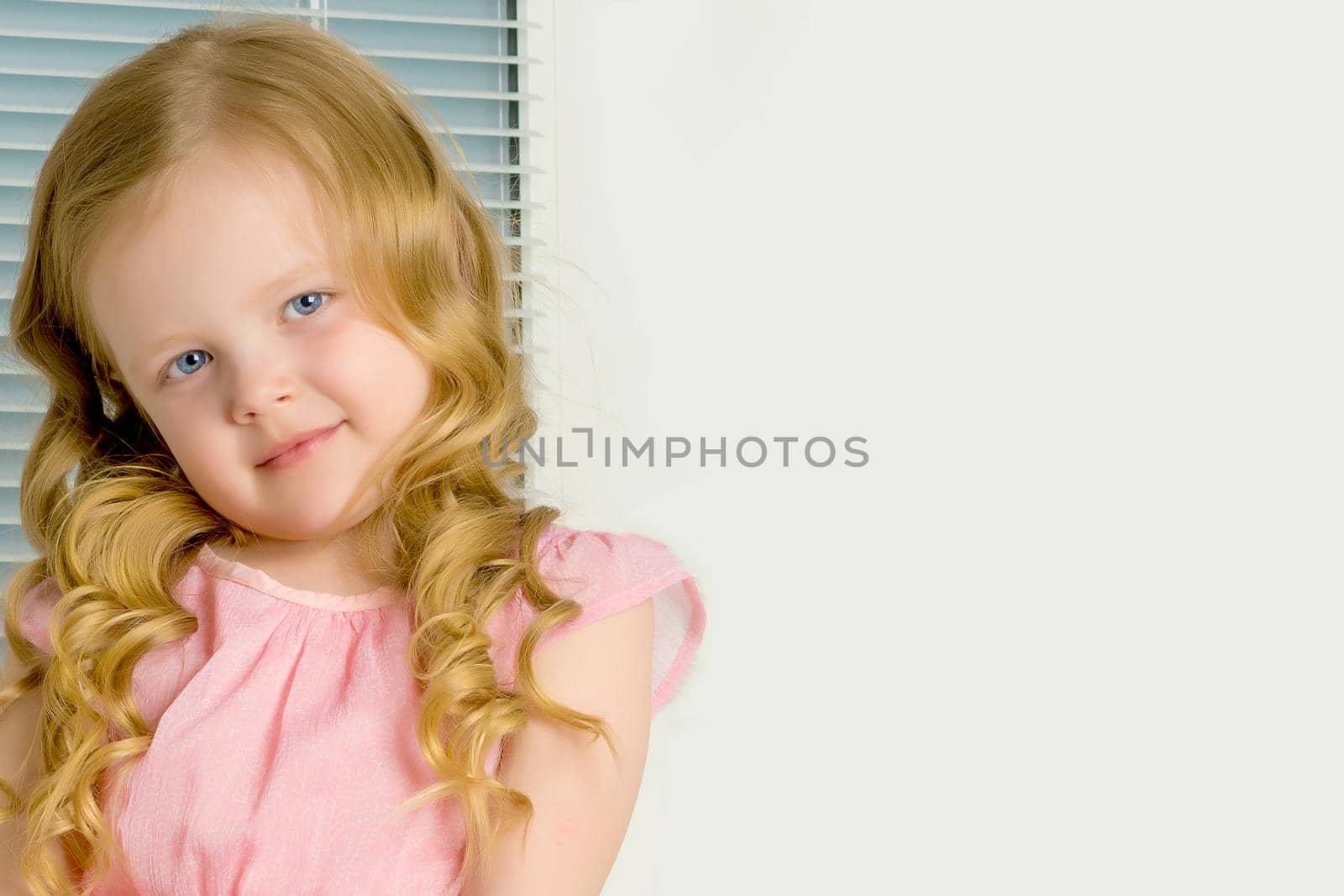 Beautiful little girl close-up. The concept of beauty and fashion, happy childhood.