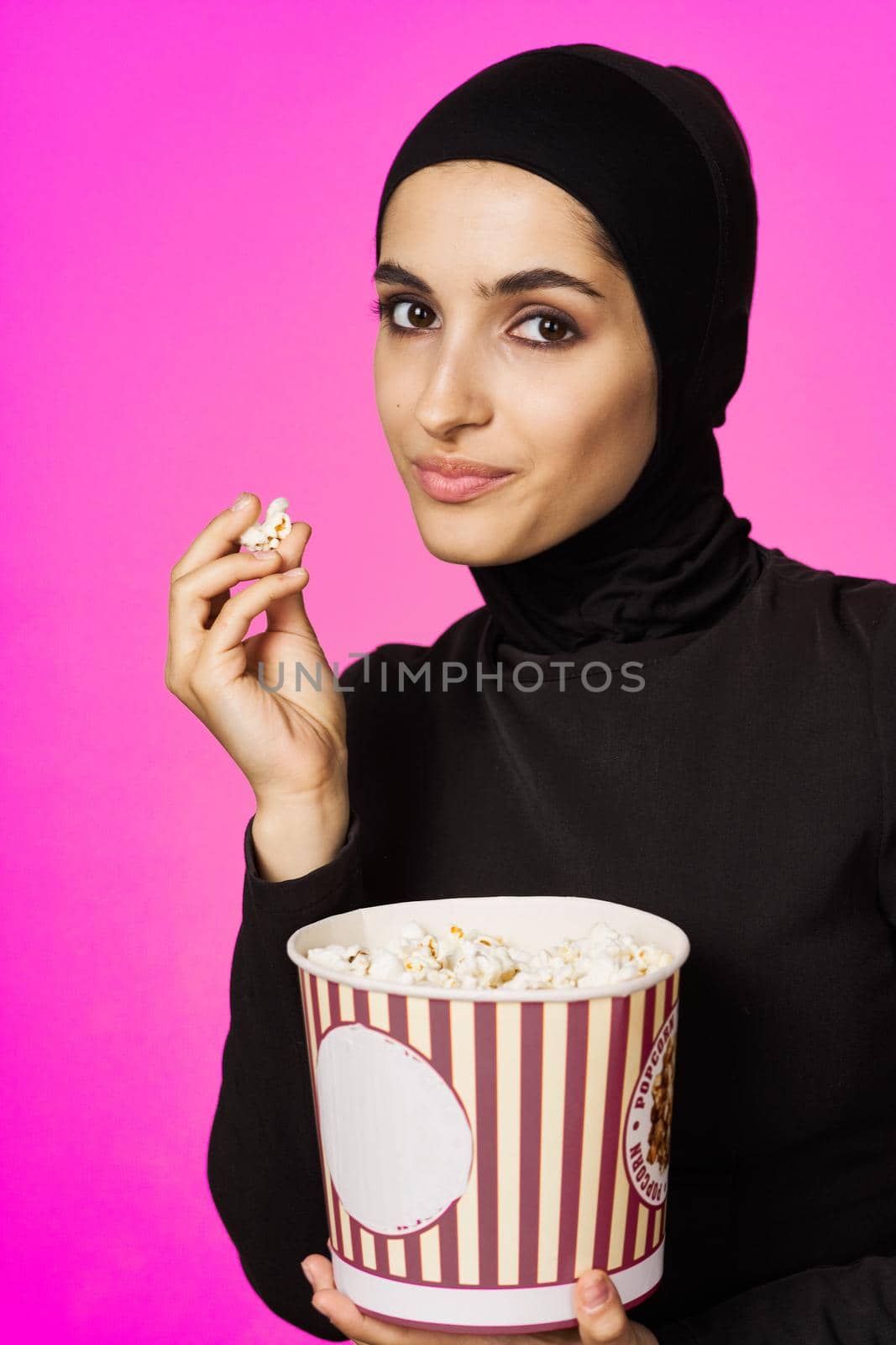 arab woman fun popcorn entertainment fashion isolated background. High quality photo