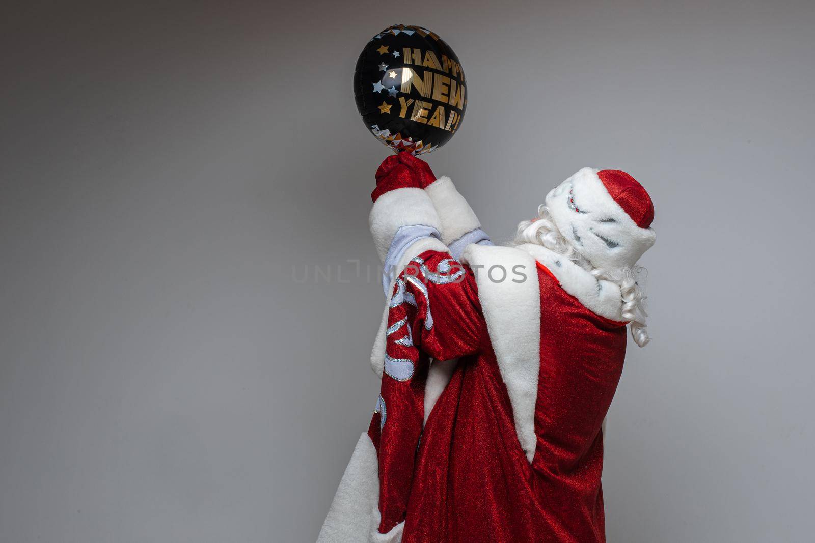 picture of old santa claus holds a baloon with wishes in his hands by StudioLucky