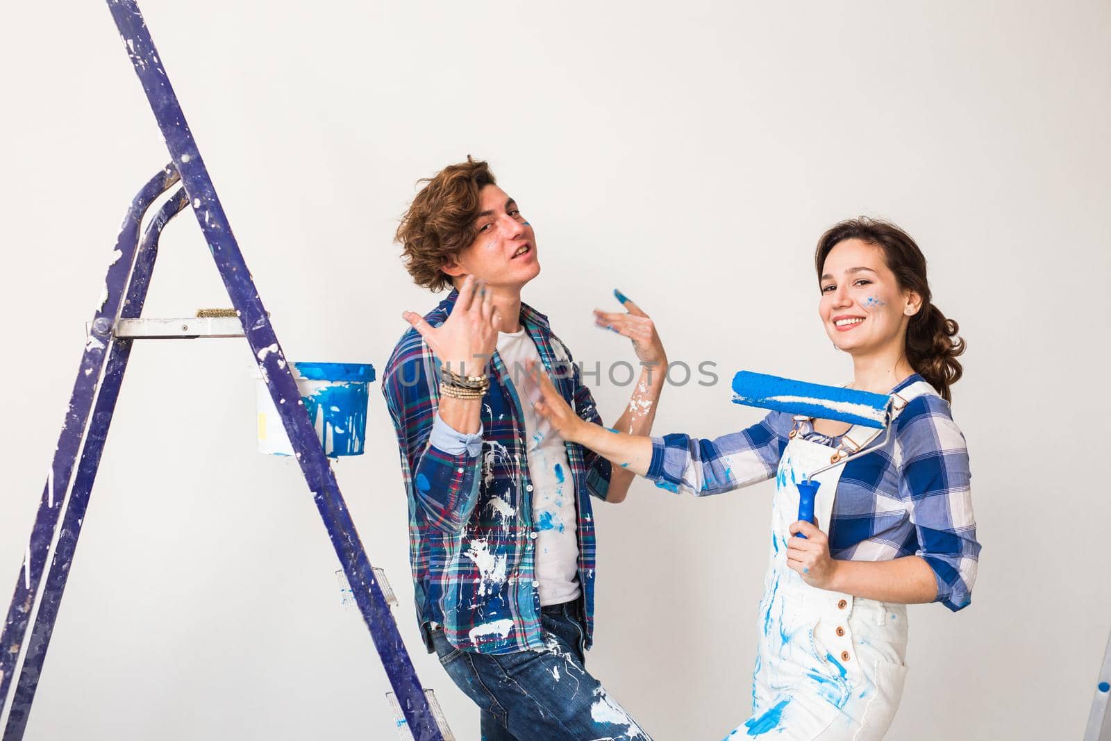 People, renovation and repair concept - Portrait of lovely couple doing redecoration in apartment.