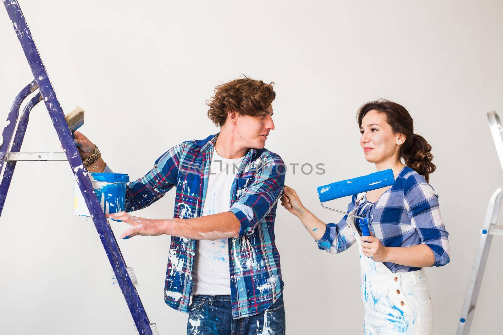 People, renovation and repair concept - Portrait of lovely couple doing redecoration in apartment by Satura86