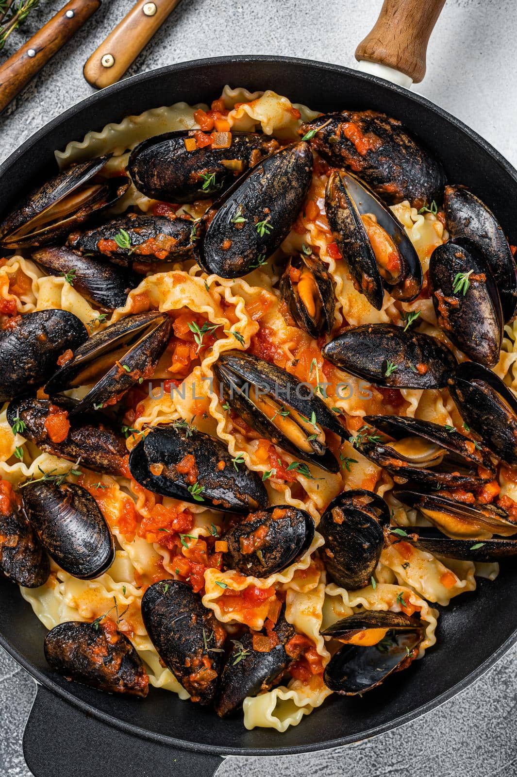 Traditional italian seafood pasta with mussels, Spaghetti and tomato sauce. White background. Top view.
