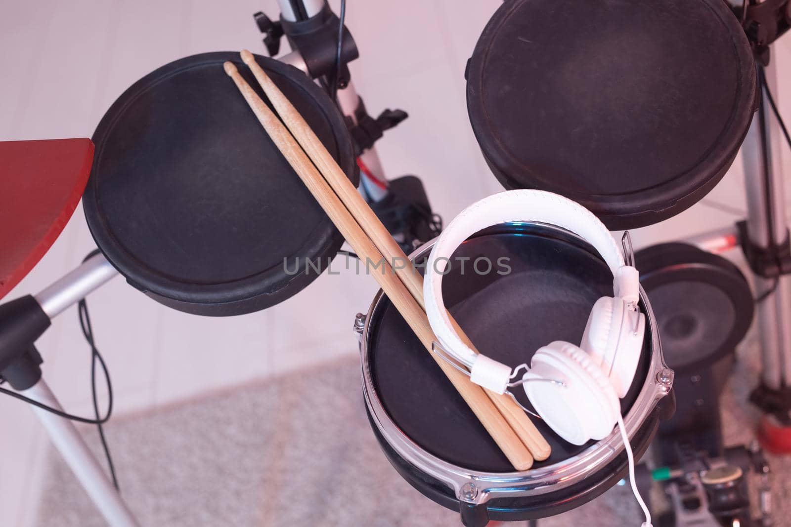 Musical instruments, hobby and music concept - headphone, drumsticks on drum.