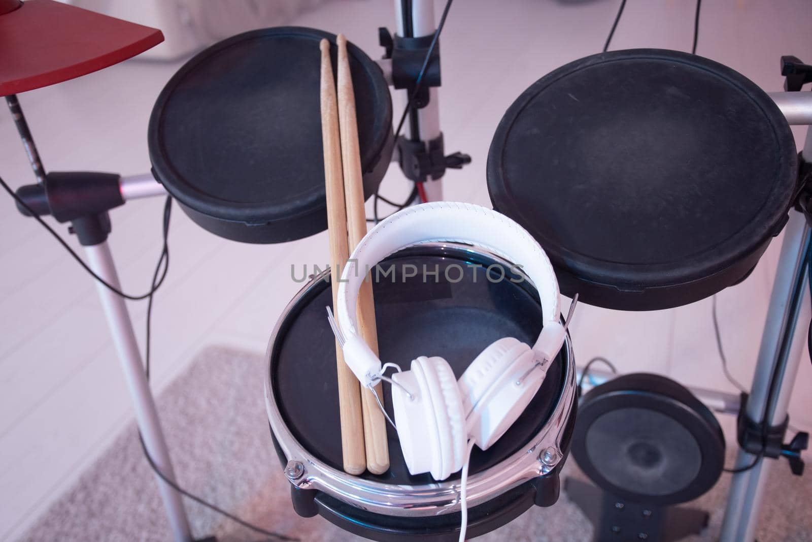 Musical instruments, hobby and music concept - headphone, drumsticks on drum by Satura86