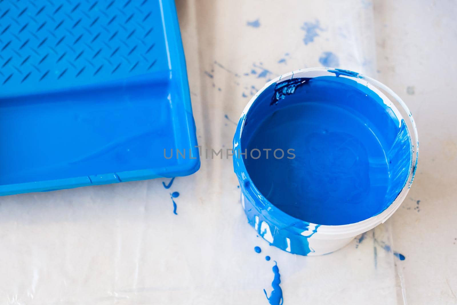 House renovation and redecoration concept - paint bucket on white floor, top view